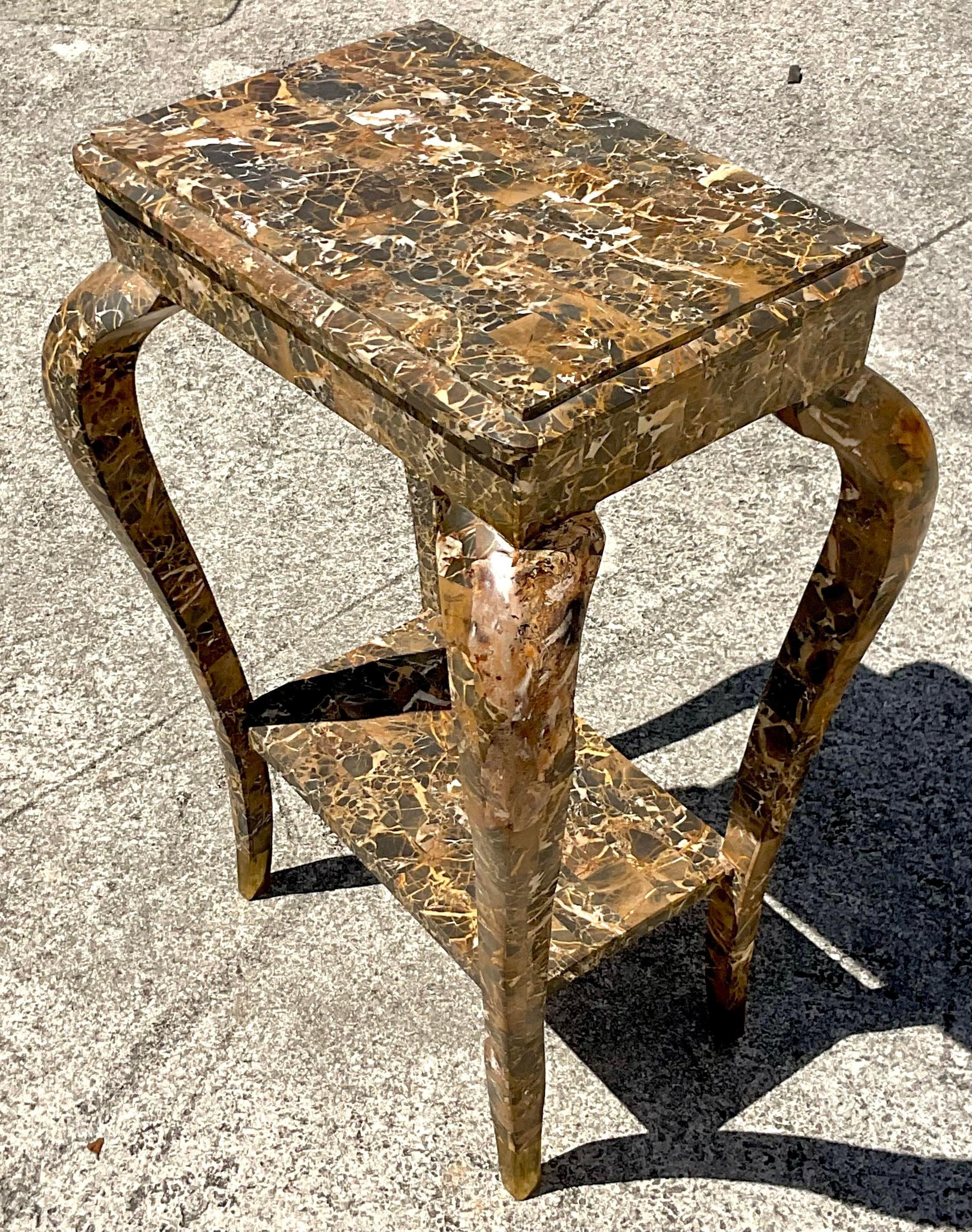 Merge classic elegance with bohemian flair in your home with our Vintage Boho Tessellated Stone Telephone Table. This piece embodies the rich tapestry of American craftsmanship, featuring intricate tessellated stone patterns and a functional design.