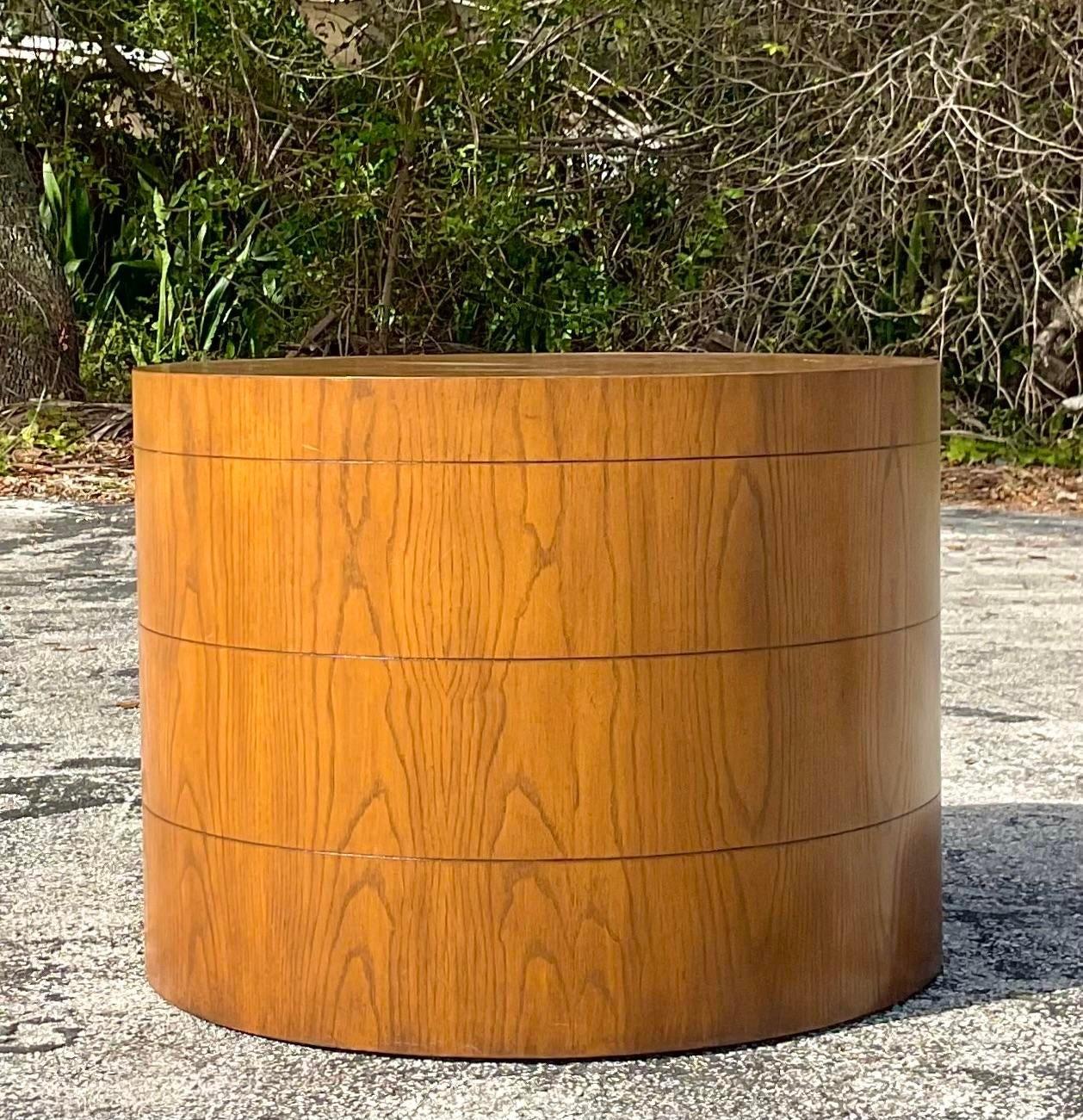 A stunning vintage Boho side table. A chic drum shape with beautiful wood grain detail. Three grouted bands along the side. Acquired from a Palm a each estate.