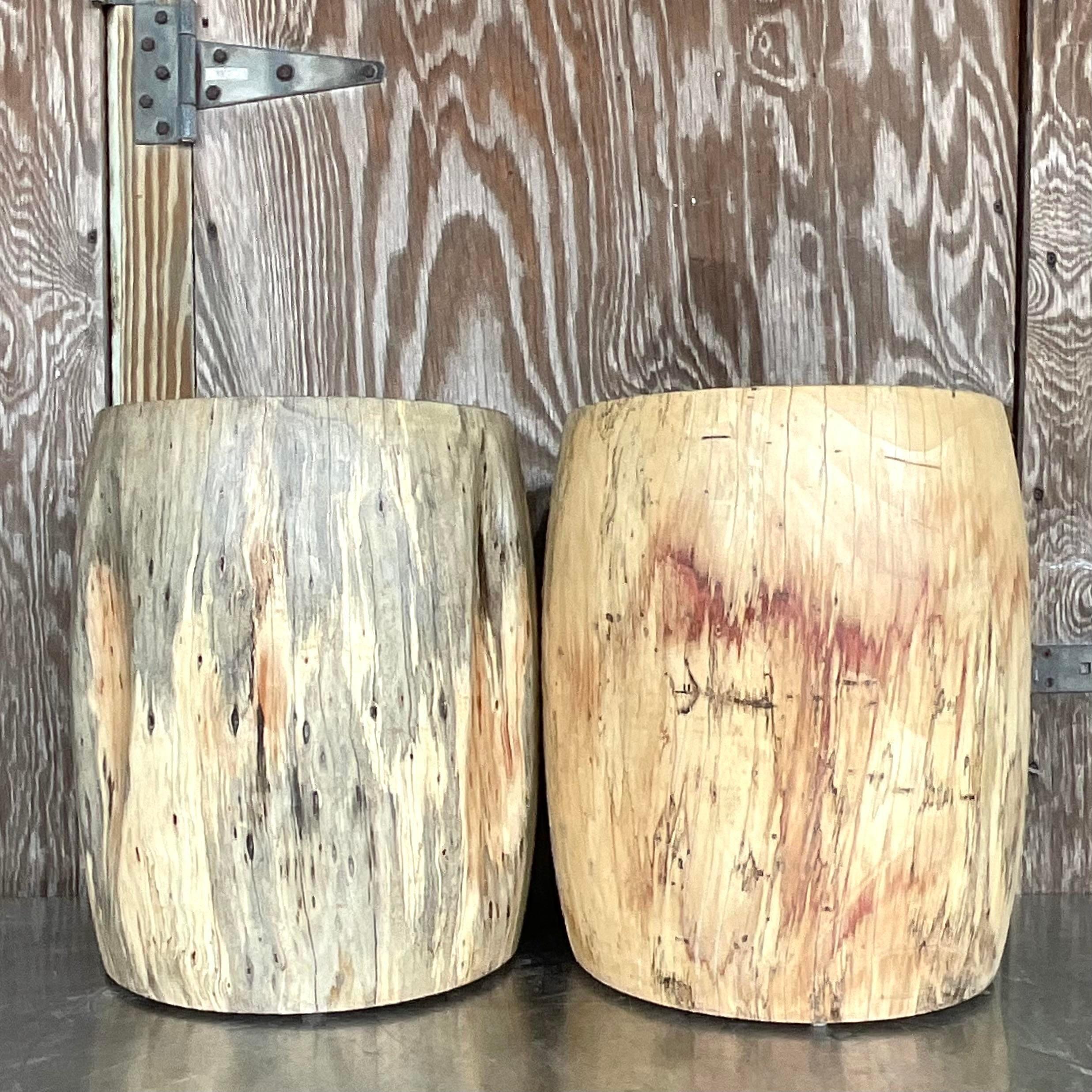 fabulous pair of vintage Boho low stools. Chic hand carved tree trunks with beautiful wood grain detail. Acquired from a Palm Beach estate.