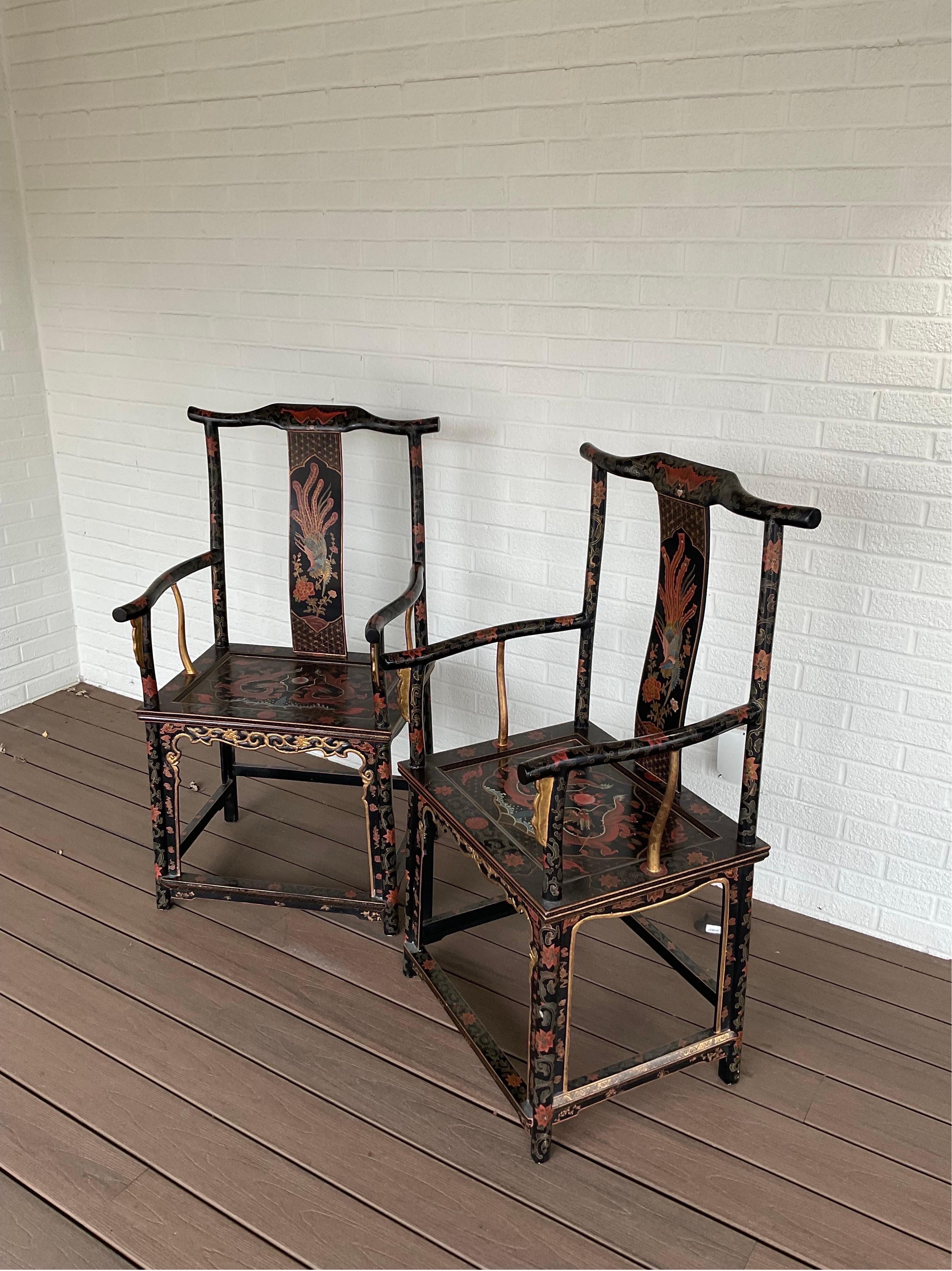 A brilliant pair chinoiserie officials arm chairs. Gorgeous hand painted details cover ever inch of the surface of these beautiful chairs. Excellent Vintage condition.