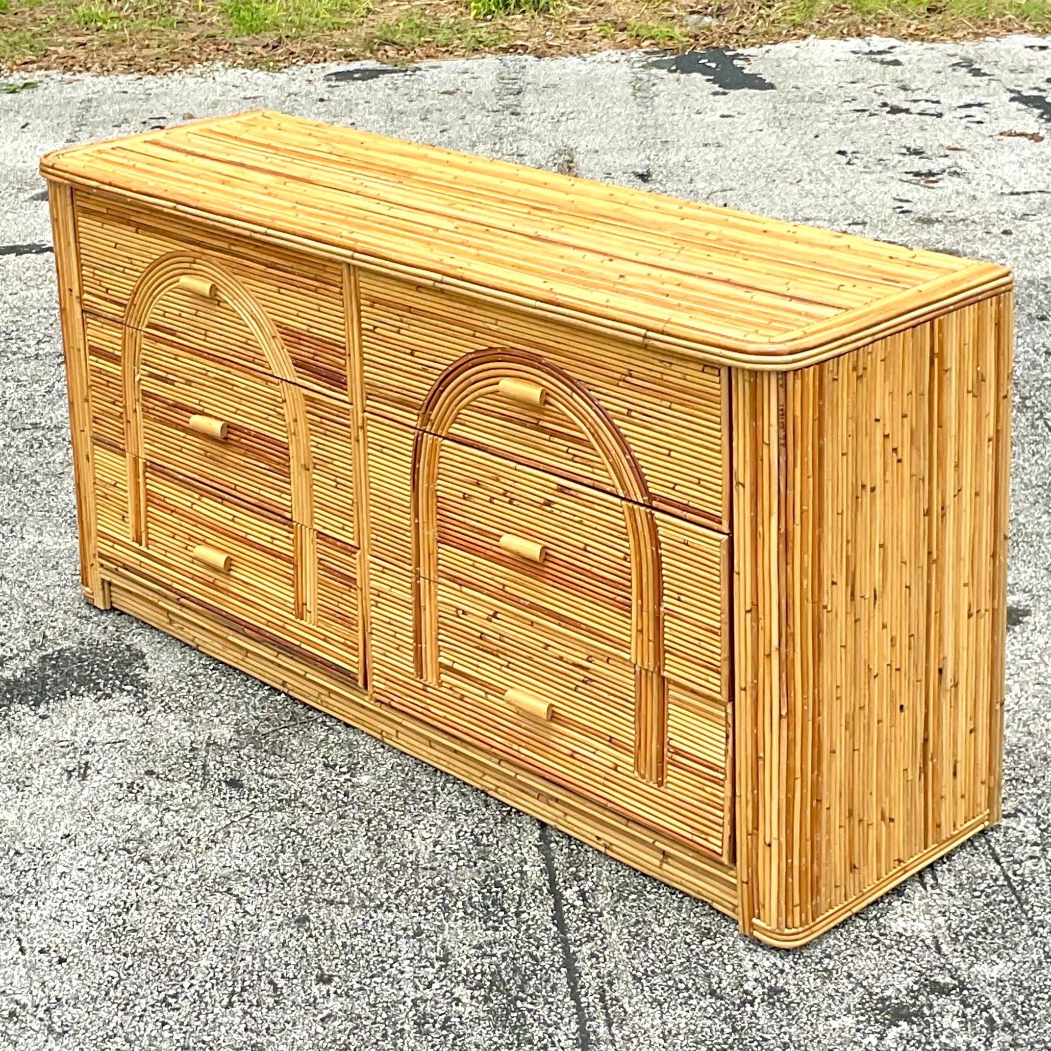 A fabulous vintage Coastal standard dresser. Beautiful pencil reed cabinet with six roomy drawers. Chic arched design in the drawer fronts. Acquired from a Palm Beach estate. 
