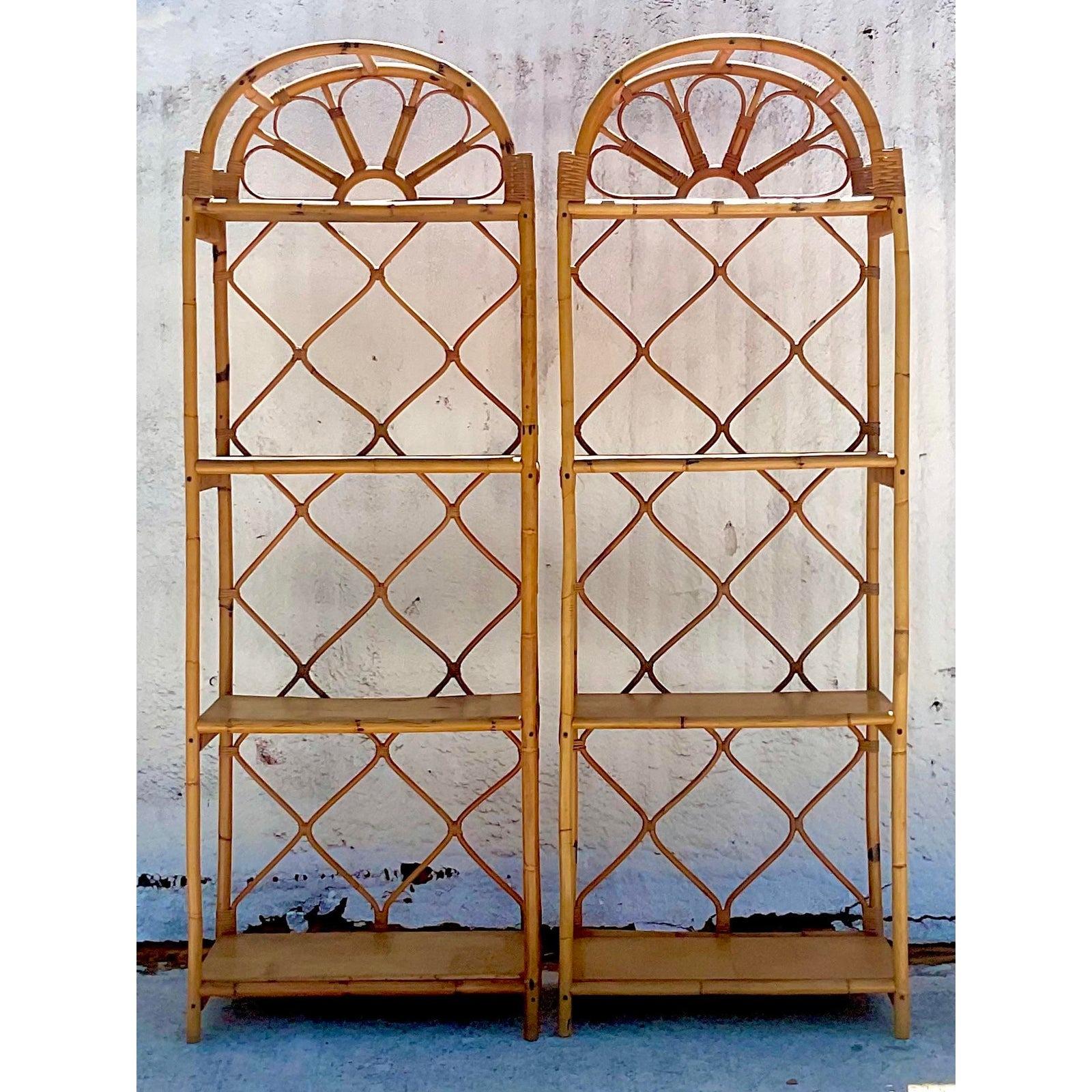 A fabulous pair of vintage Coastal etagere. Beautiful bent rattan in a chic arched design. Wooden shelves. Acquired from a Palm Beach estate.