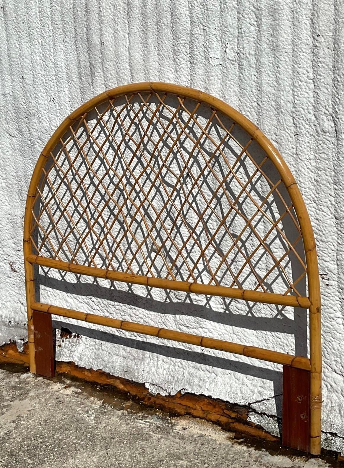A fabulous vintage Coastal arched rattan full headboard. A chic trellis design with a warm rich patina from time. Acquired from a Palm Beach estate. 