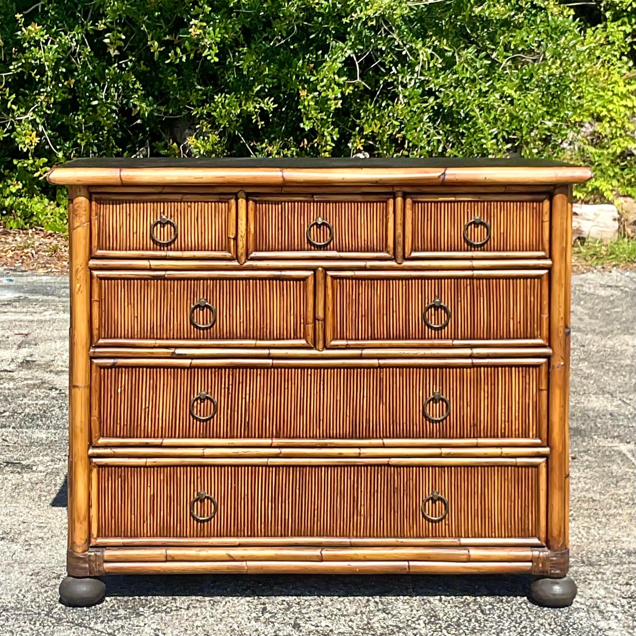 Bring coastal charm to your home with this Vintage Coastal Baker Milling Road Bamboo Chest of Drawers. This American-style piece features a beautifully crafted bamboo design, blending functionality with relaxed elegance. Ideal for adding a touch of