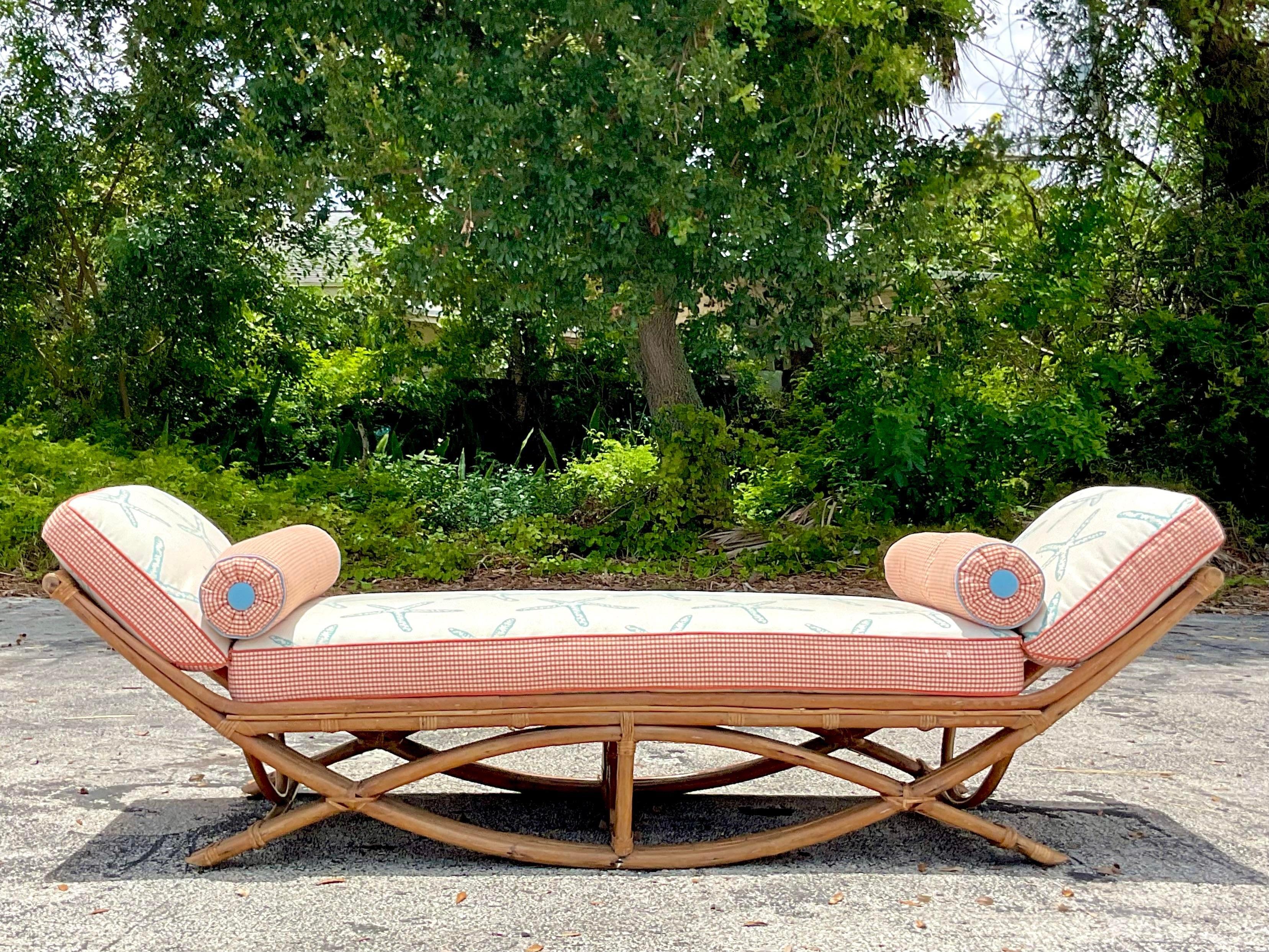 Vintage Coastal bent bamboo day bed. A chic gondola design with custom cushion and coordinating bolster cushions. Acquired from a Palm Beach estate.