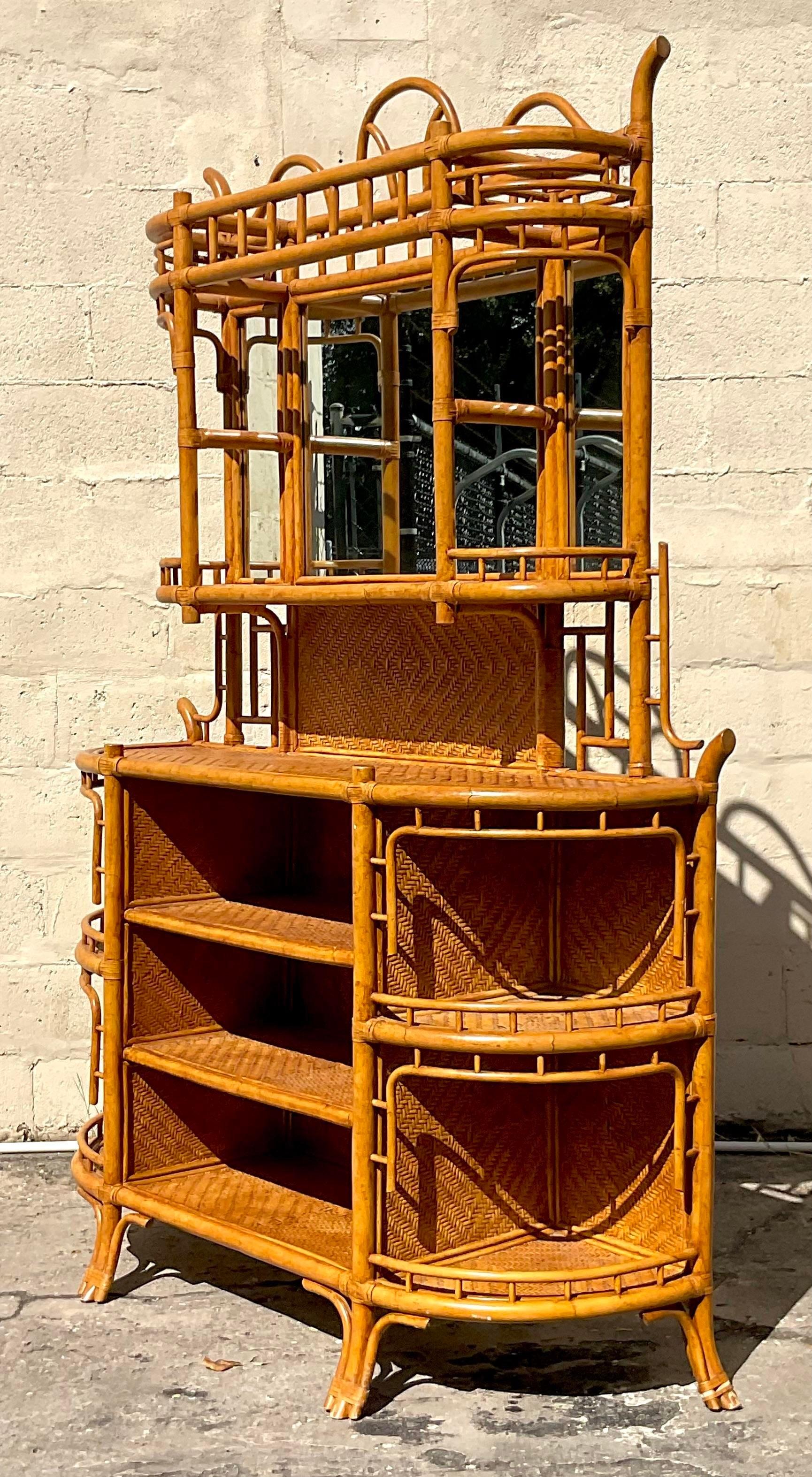 A stunning vintage Coastal dry bar. Gorgeous bent rattan with inset woven rattan panels. Gorgeous mirror hutch on top. Perfect as a dry bar, China hutch or orchid display. You decide! Acquired from a Palm Beach estate.
