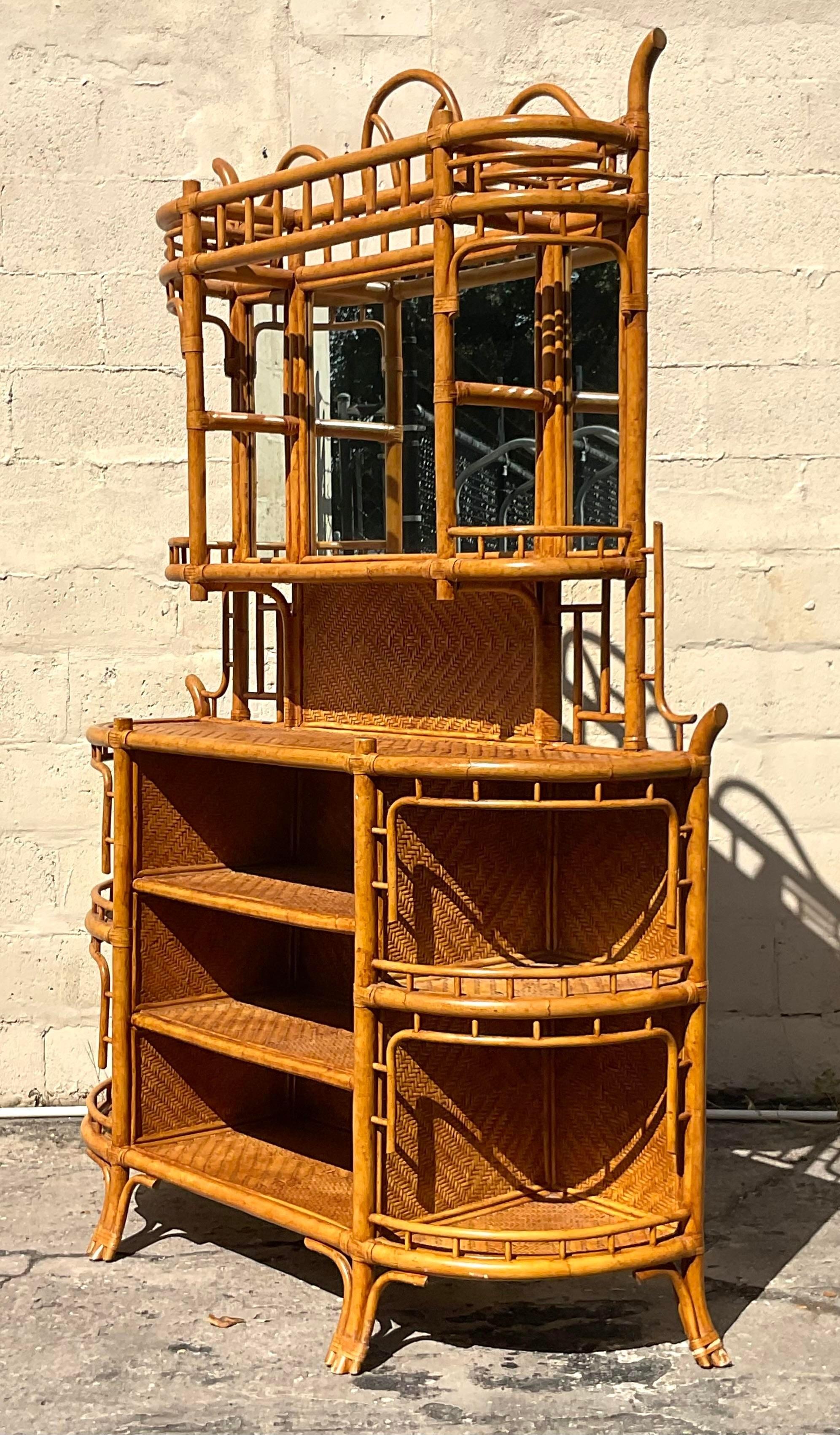 A stunning vintage Coastal dry bar. Gorgeous bent rattan with inset woven rattan panels. Gorgeous mirror hutch on top. Perfect as a dry bar, China hutch or orchid display. You decide! Acquired from a Palm Beach estate.