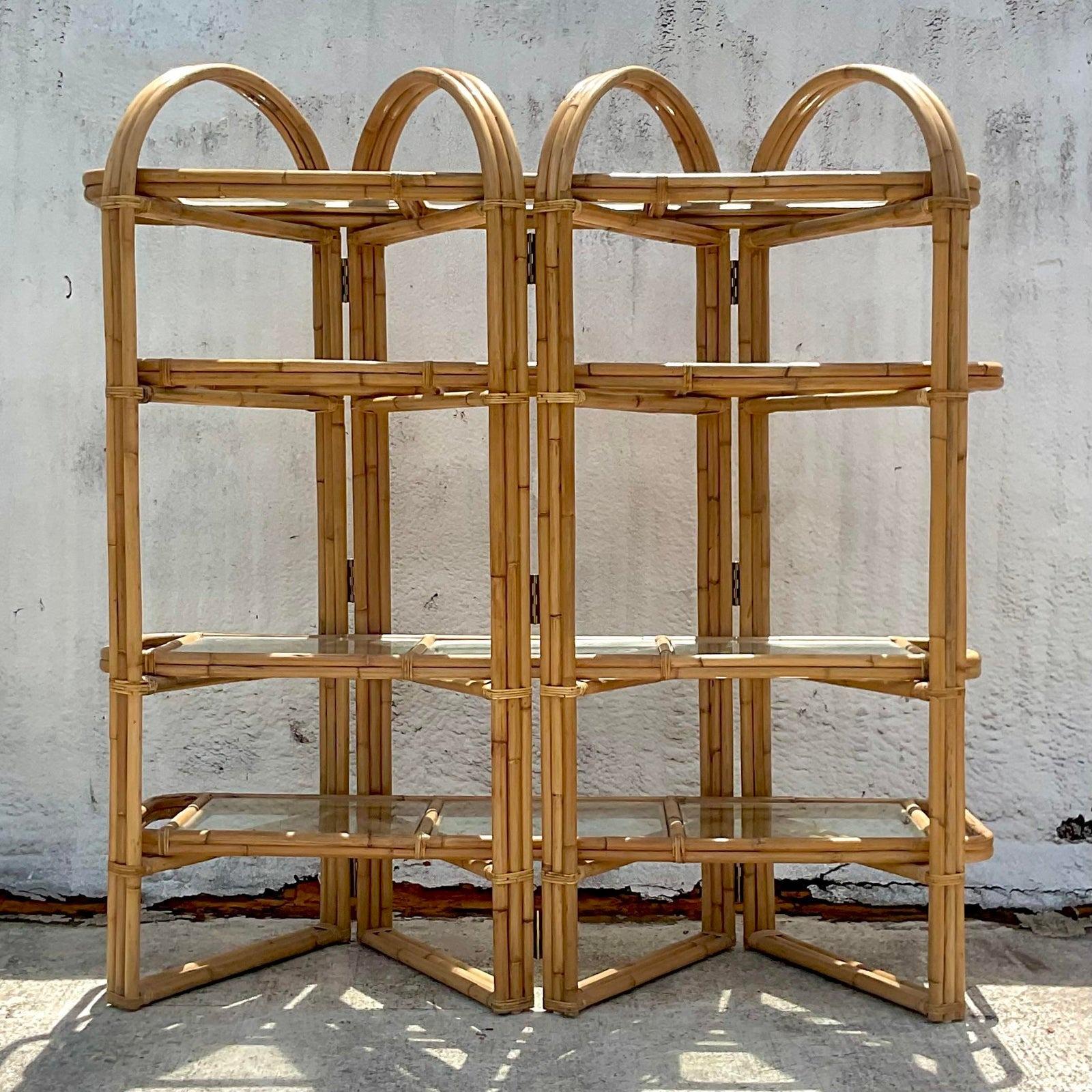 A fabulous vintage Coastal etagere. Beautiful bent rattan in a folding arch design. Inset rattan framed glass shelves. Acquired from a Palm Beach estate.