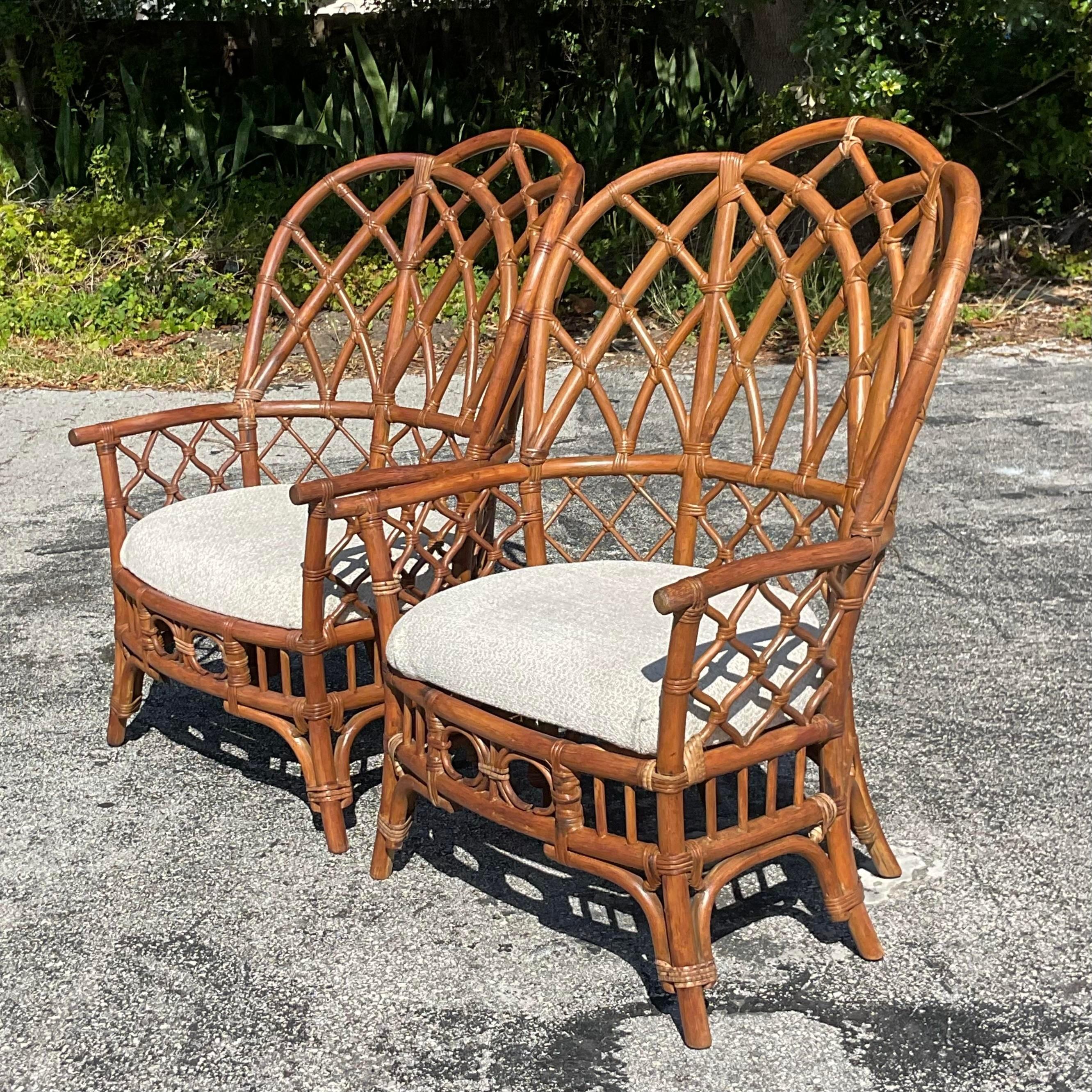 Indulge in coastal charm with this delightful pair of Vintage Bent Rattan Wingback Chairs, exuding timeless American elegance. Crafted with intricate rattan weaving and classic wingback design, they offer both comfort and style for any coastal