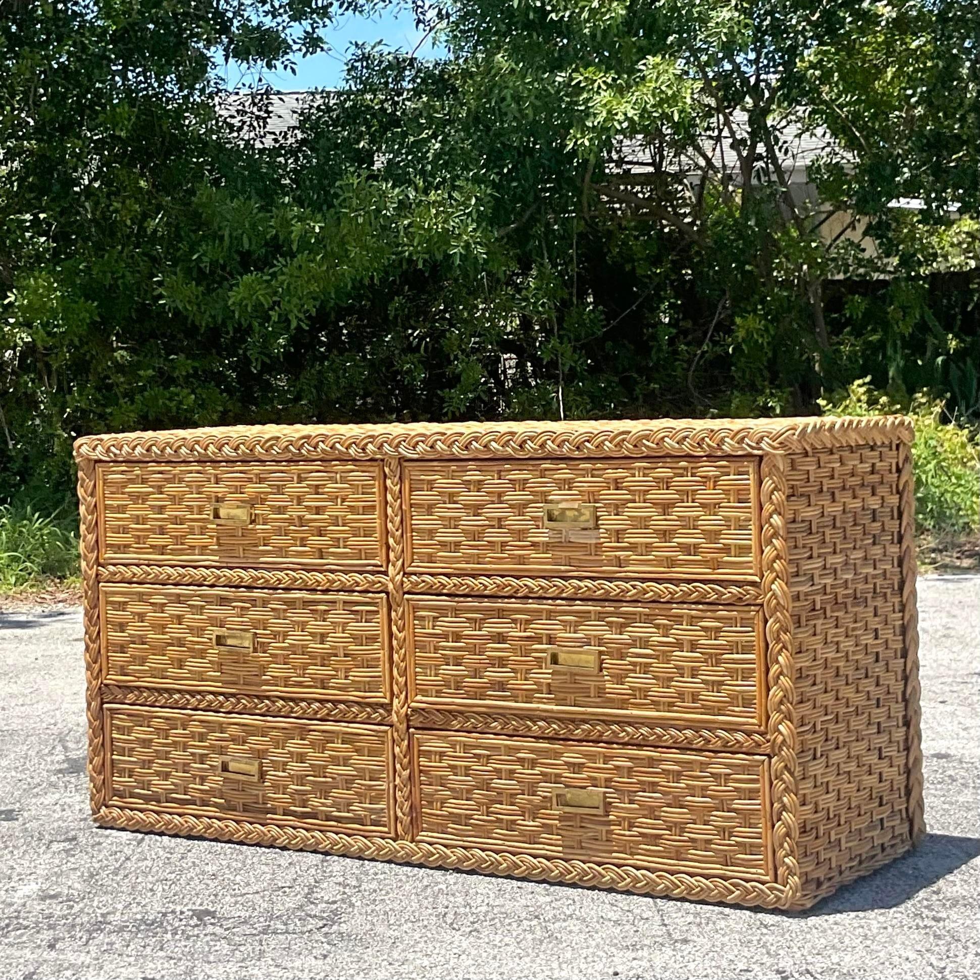 Embrace coastal elegance with this vintage braided rattan dresser. Handcrafted with American craftsmanship, its intricate braided design exudes seaside charm while providing functional storage, making it the perfect addition to any coastal-inspired