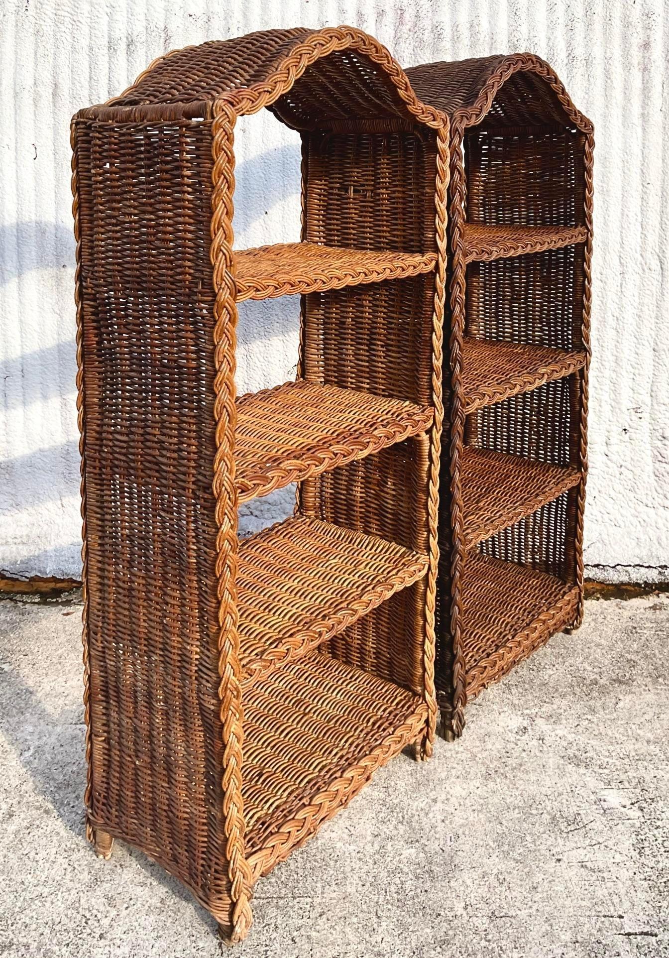 A fabulous pair of vintage Coastal etagere. Chic braided rattan in a rolling arch shape. Interior rattan shelves. Currently in need of a full restoration. We would do that except we they look great as is. Structurally sounds, just have been exposed