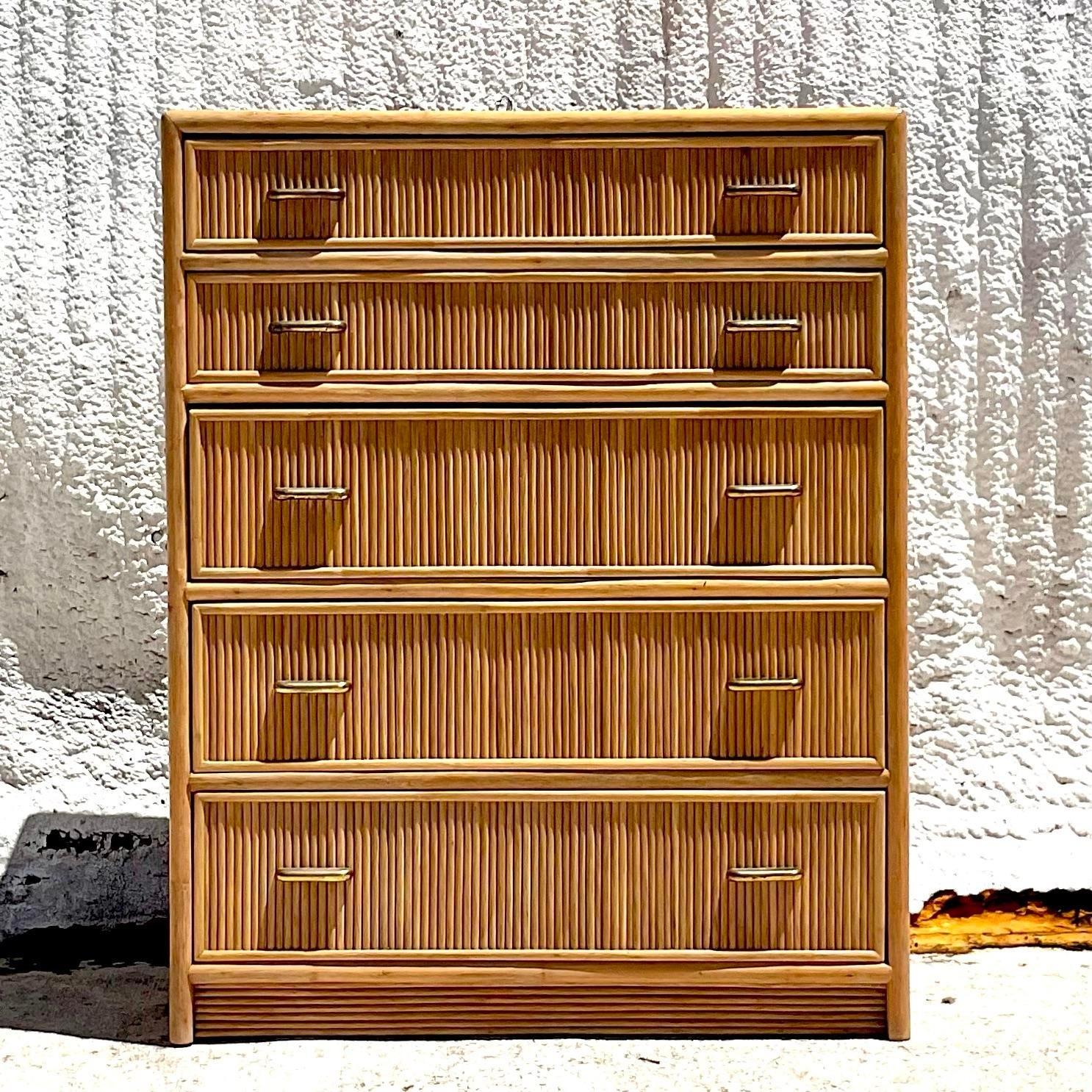 A stunning vintage Coastal tall chest of drawers. Made by the iconic Brown Jordan group and tagged inside the drawer. Beautiful rattan cabinet with brass hardware. Acquired from a Palm Beach estate.
