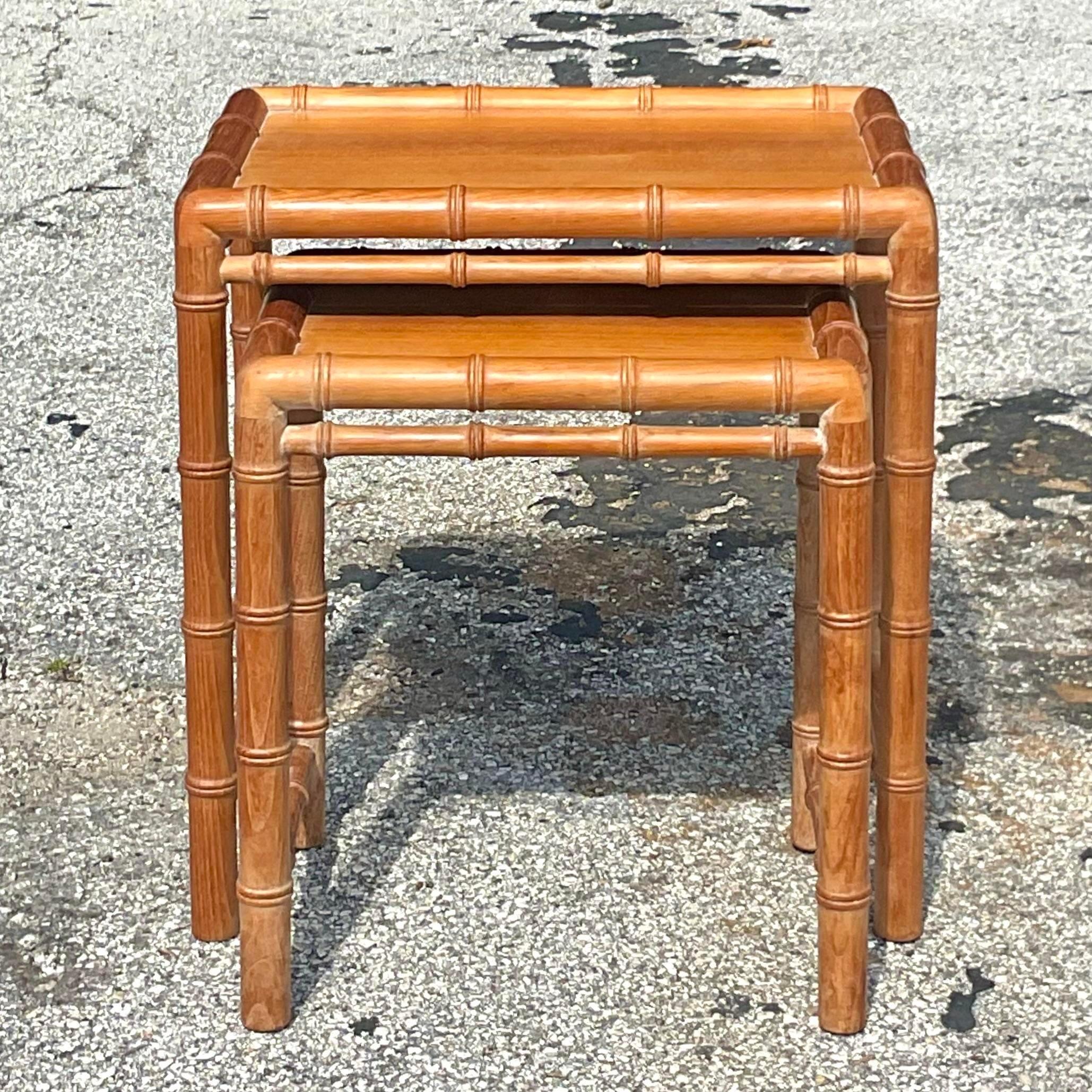 A fabulous little set of vintage Coastal nesting tables. Chic carved bamboo style in a warm khaki color. Acquired from a Palm Beach estate.

Smaller table - 15.75x11.75x18