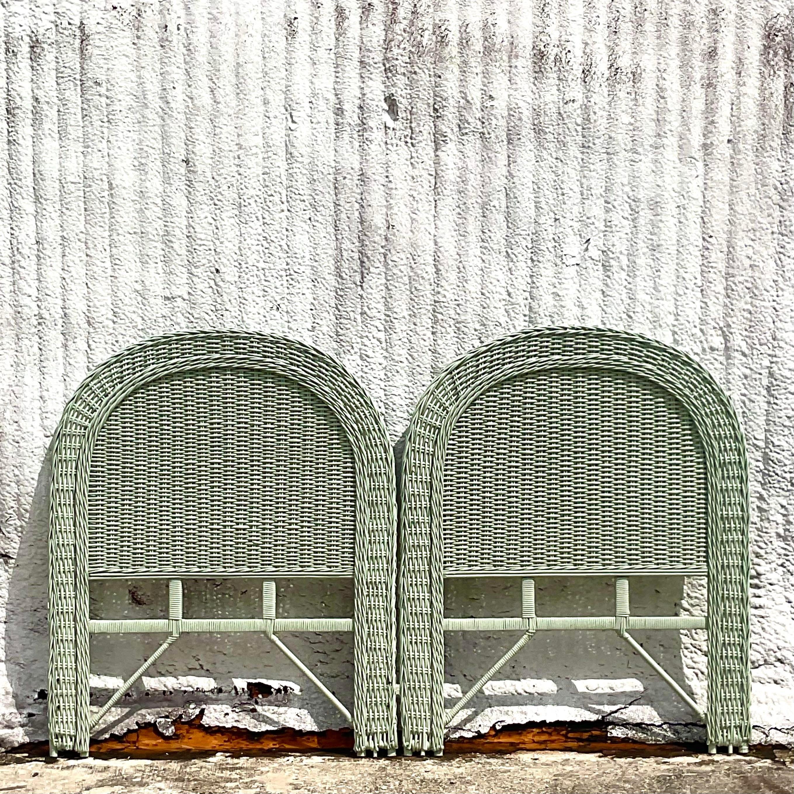 A fabulous pair of vintage Coastal twin headboards. A chic celadon color on a woven rattan frame. Acquired from a Palm Beach estate. 