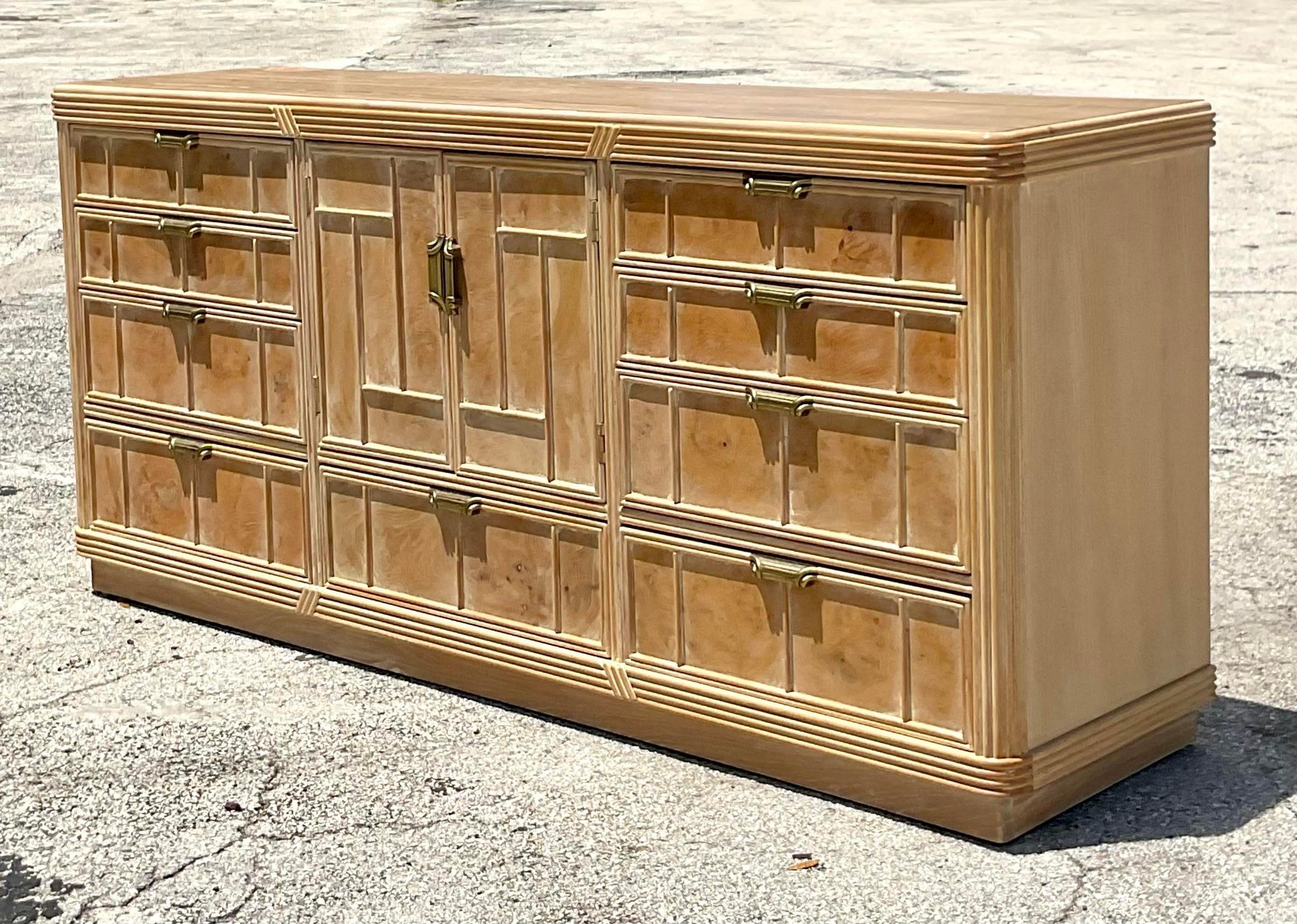 A gorgeous vintage Coastal credenza. A chic cerused Burl wood with a great patina from time. The center door opens to reveal these additional drawers for storage. Acquired from a Delray estate.