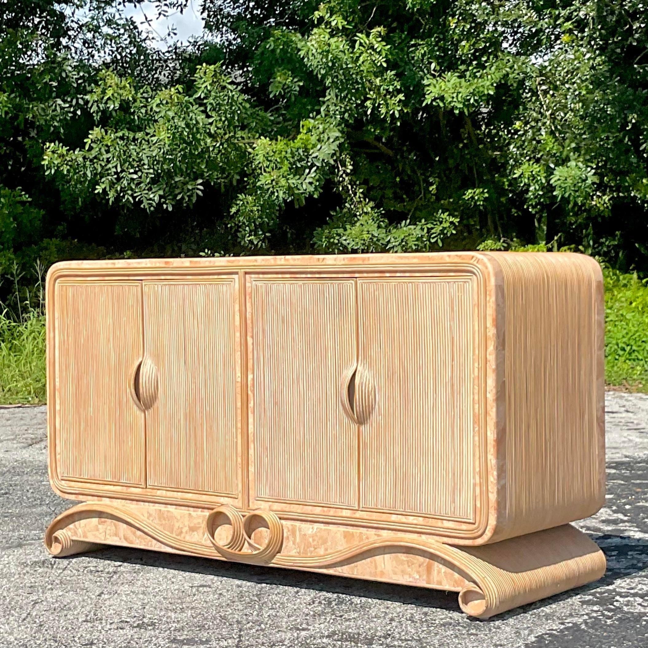 A fabulous vintage Coastal credenza. A chic pencil reed frame with a gorgeous tessellated stone trim. Lots of great interior storage. Acquired from a Palm Beach estate.