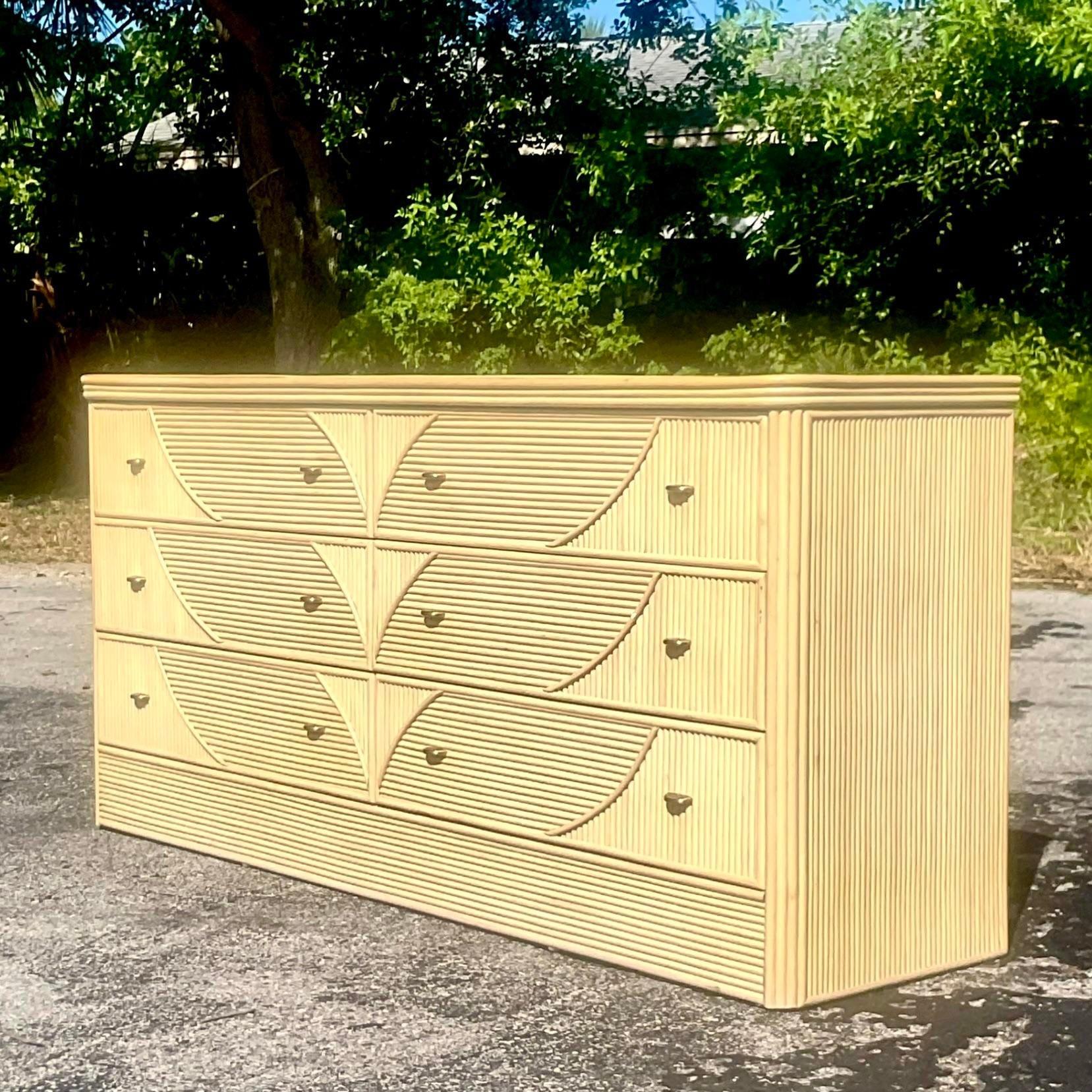 A fabulous vintage Coastal dresser. A chic cerused pencil reed with a leaf design. Acquired from a Palm Beach estate.