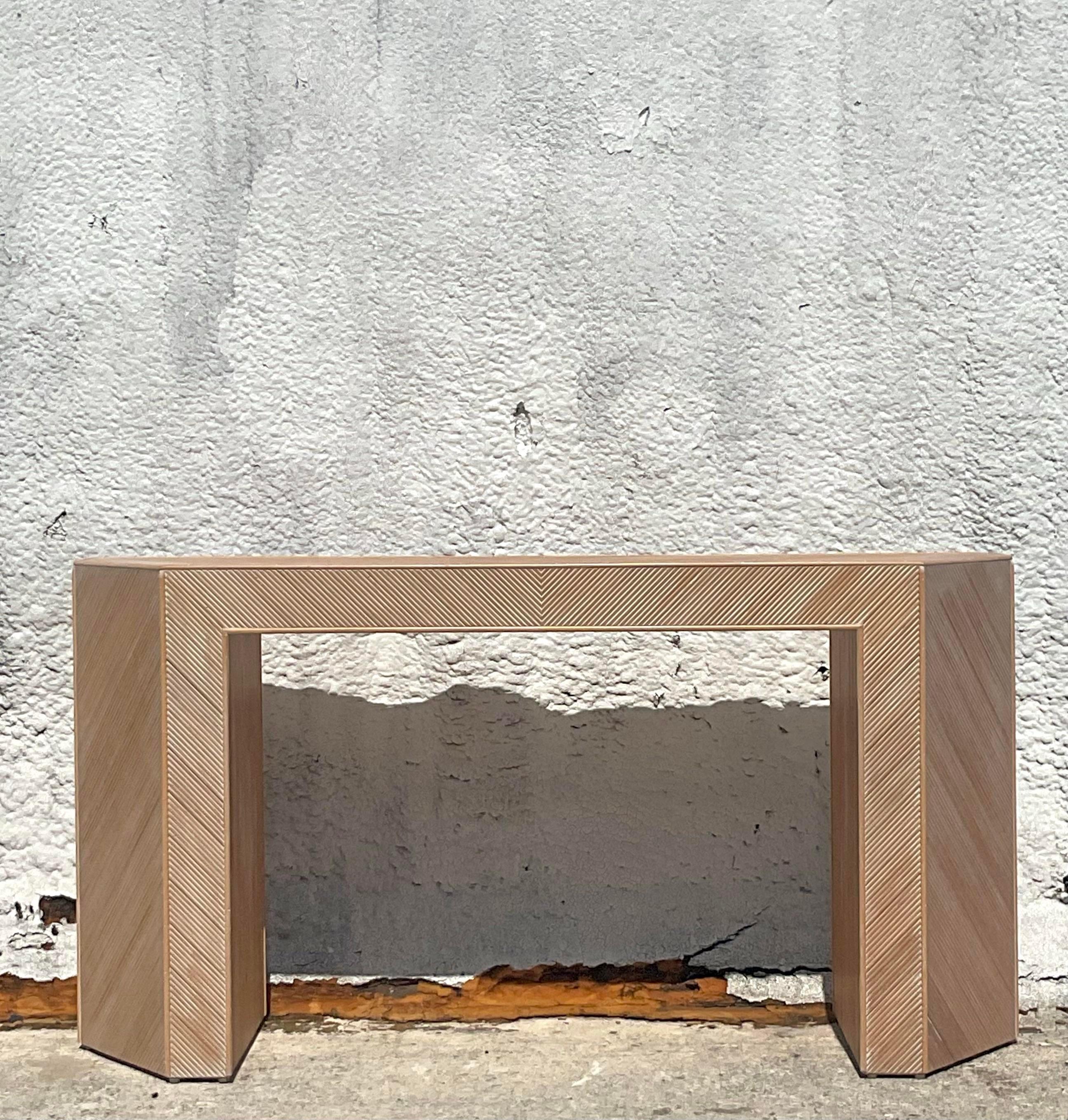 Enhance your decor with this Vintage Coastal Chevron Pencil Reed Faceted Console Table. Showcasing a distinctive chevron pattern and faceted design, this table combines coastal charm with classic American sophistication, making it a stylish addition