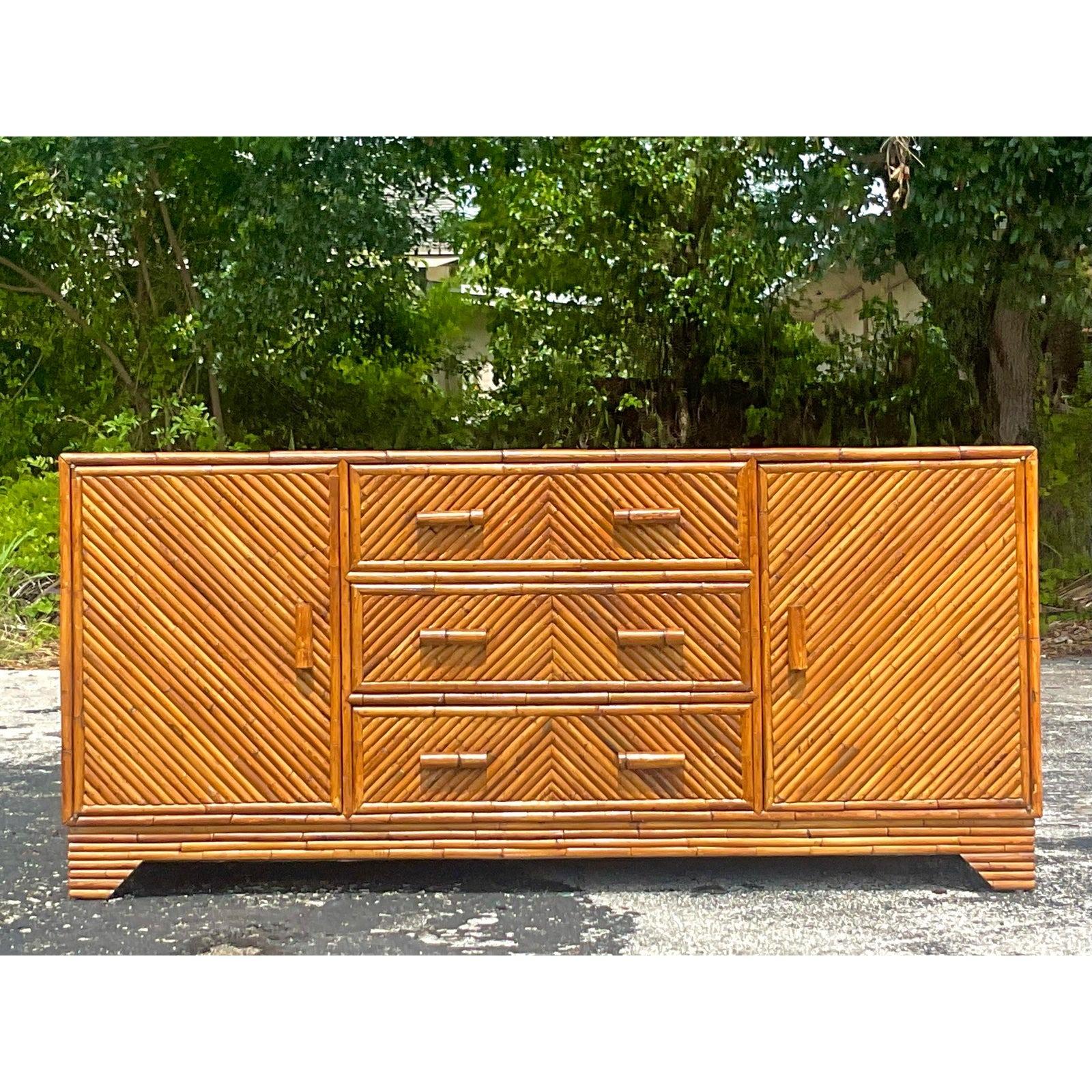 A truly spectacular vintage Coastal credenza. Chic thick rattan in a Chevron design. Lots of great storage below with cabinets and drawers. Acquired from a Palm Beach estate.