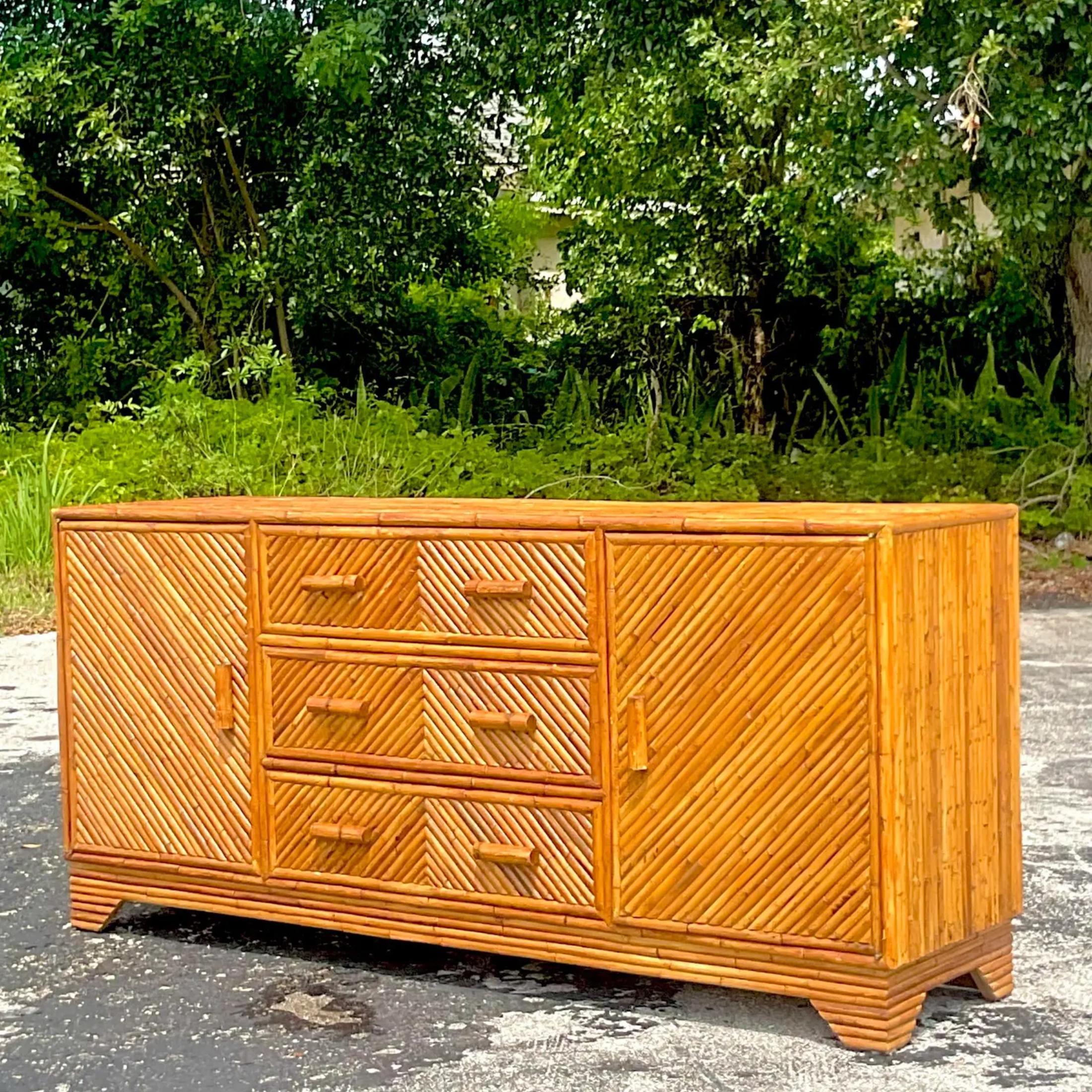 A truly spectacular vintage Coastal credenza. Chic thick rattan in a Chevron design. Lots of great storage below with cabinets and drawers. Acquired from a Palm Beach estate