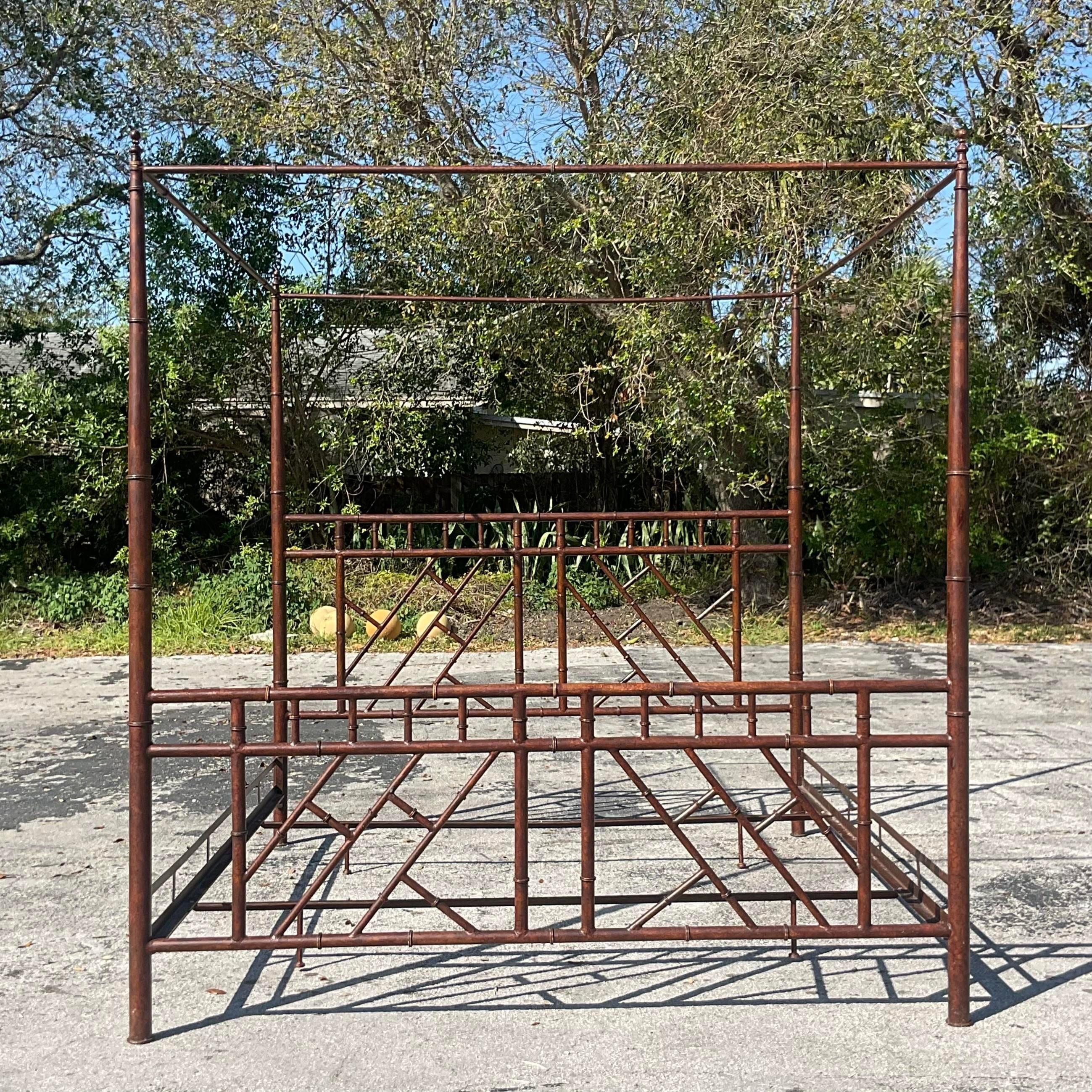 A stunning vintage Boho King canopy bed. A chic faux finished metal frame in a Chinese Chippendale design. Acquired from a Palm Beach estate.