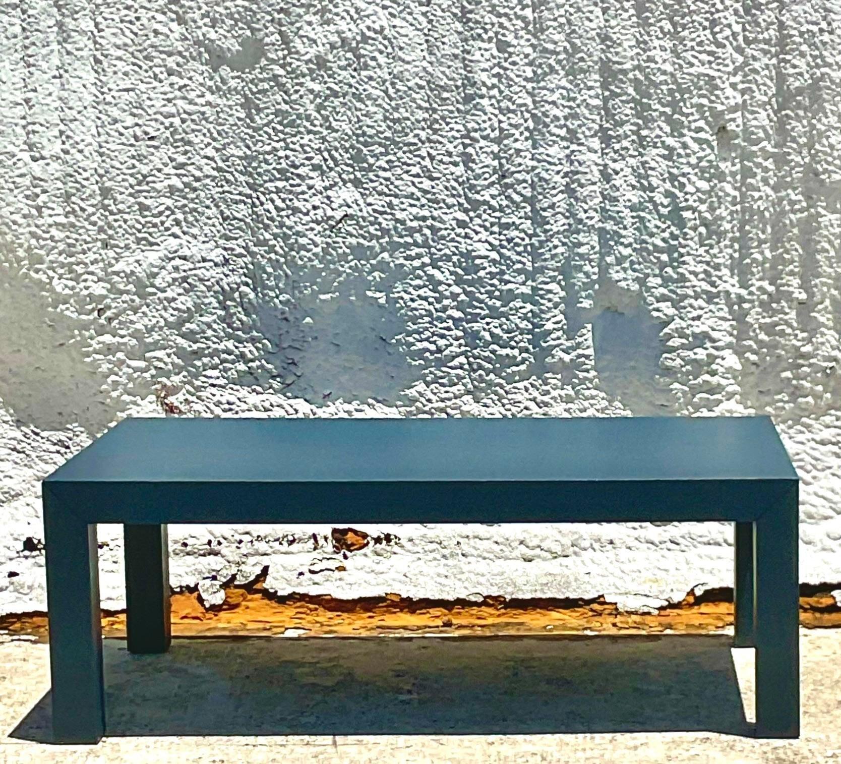 A fabulous vintage Coastal coffee table. A chic Grasscloth surface painted a beautiful steely blue. Easily painted to suit your project. A chic and clean Parsons shape. Acquired from a Palm Beach estate.