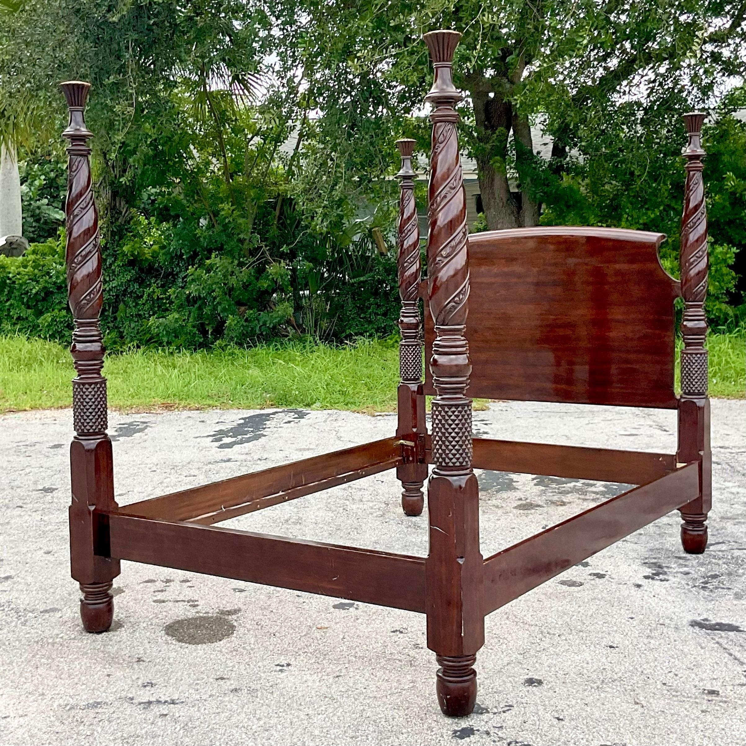 A fabulous vintage Regency Queen bed frame. A chic four posted design with hand carved vine detail. Gorgeous Mahogany wood grain detail. Acquired from a Palm Beach estate.