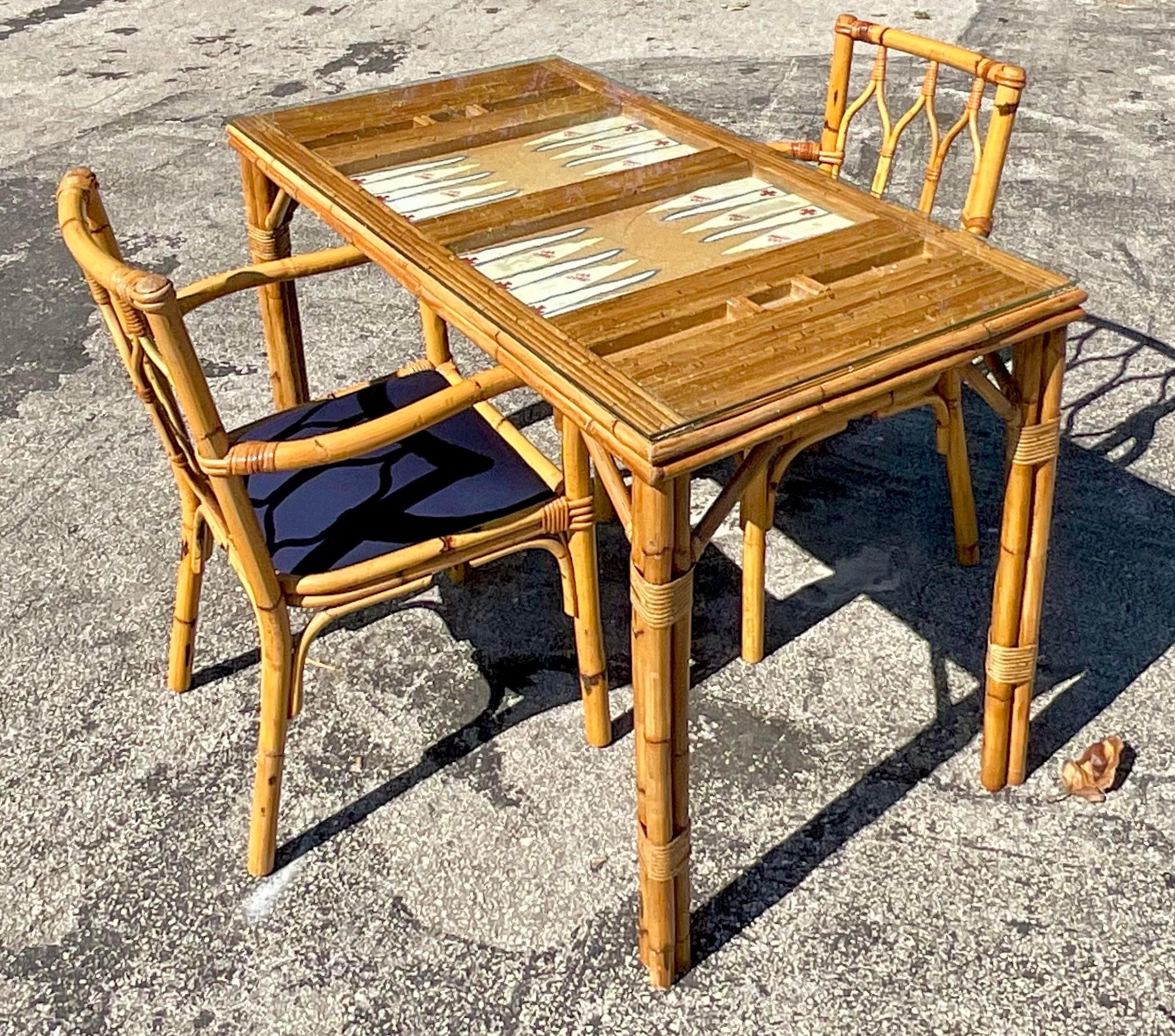 Immerse yourself in timeless charm with this Vintage Coastal Hand-Painted Game Table Set of 3, a quintessential expression of American craftsmanship and coastal allure. Each piece is meticulously crafted and adorned with intricate hand-painted