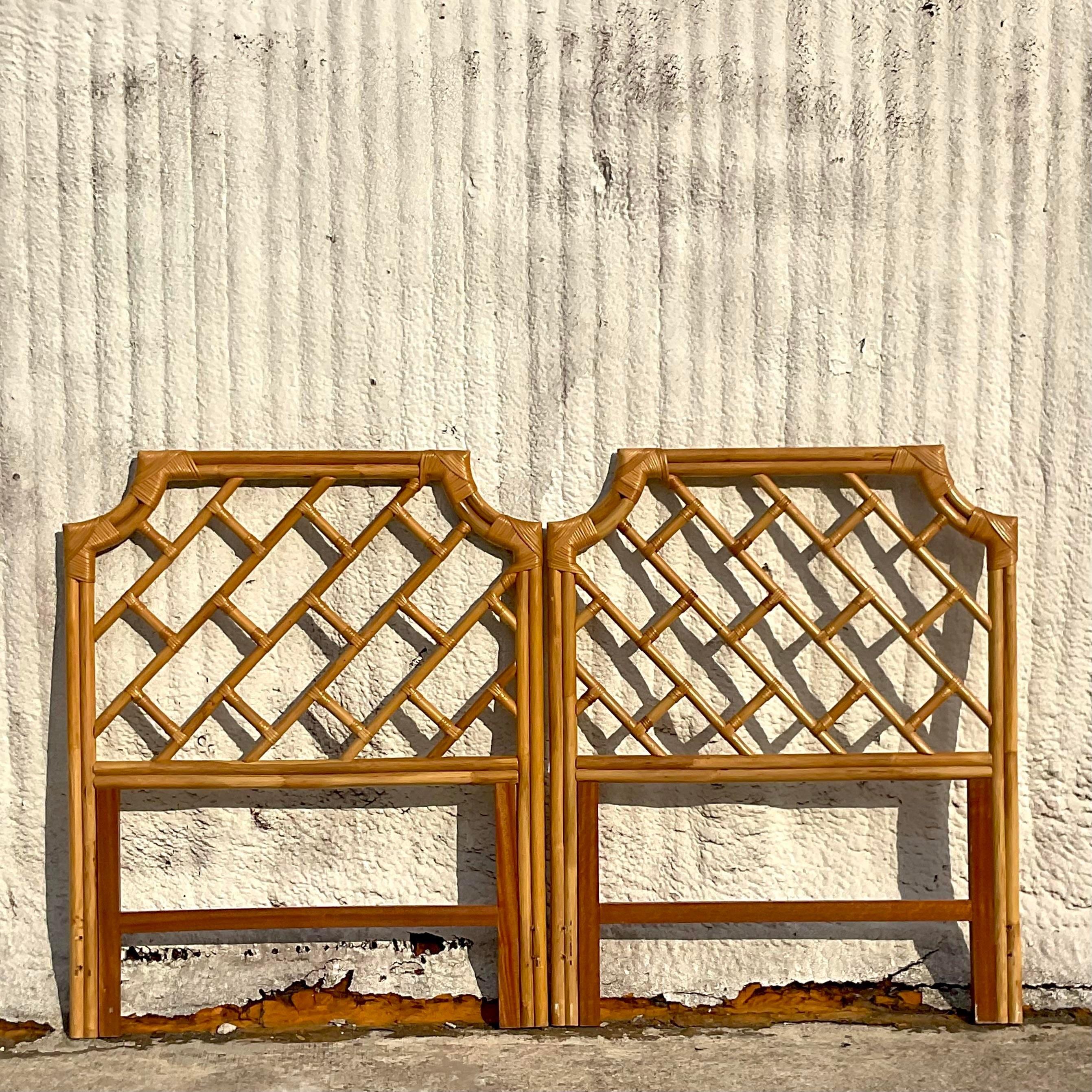 A stunning pair of vintage Coastal twin headboards. A chic bent rattan in a notched corner design. Acquired from a Palm Beach estate.