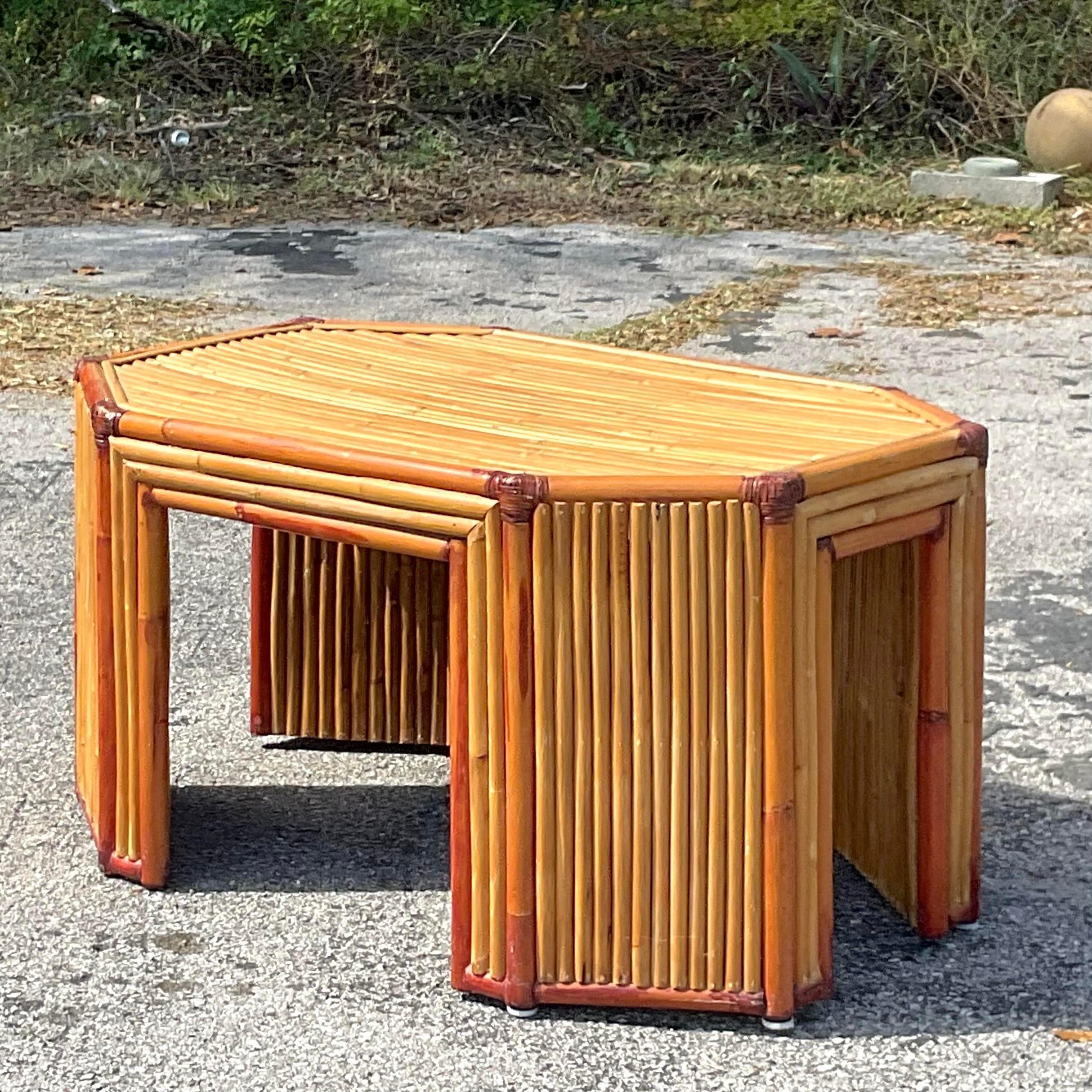 A fabulous vintage Coastal rattan coffee table. A chic faceted octagon shape in thick rattan trimmed in bamboo. A super stylish table. Acquired from a Palm Beach estate.