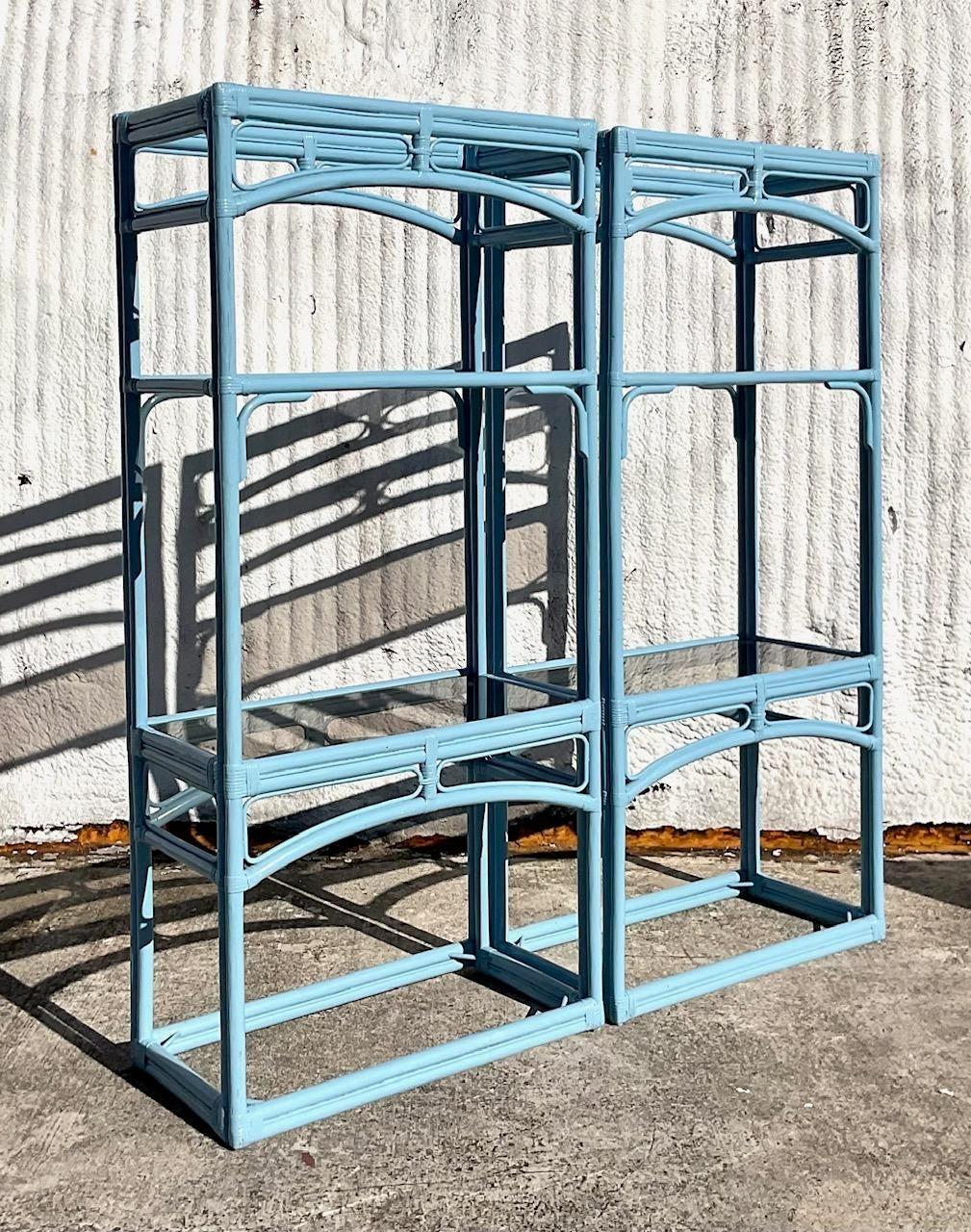 A fabulous pair of vintage Coastal etagere. A classic shape painted a brilliant blue. Inset tinted glass shelves. Acquired from a Palm Beach estate.