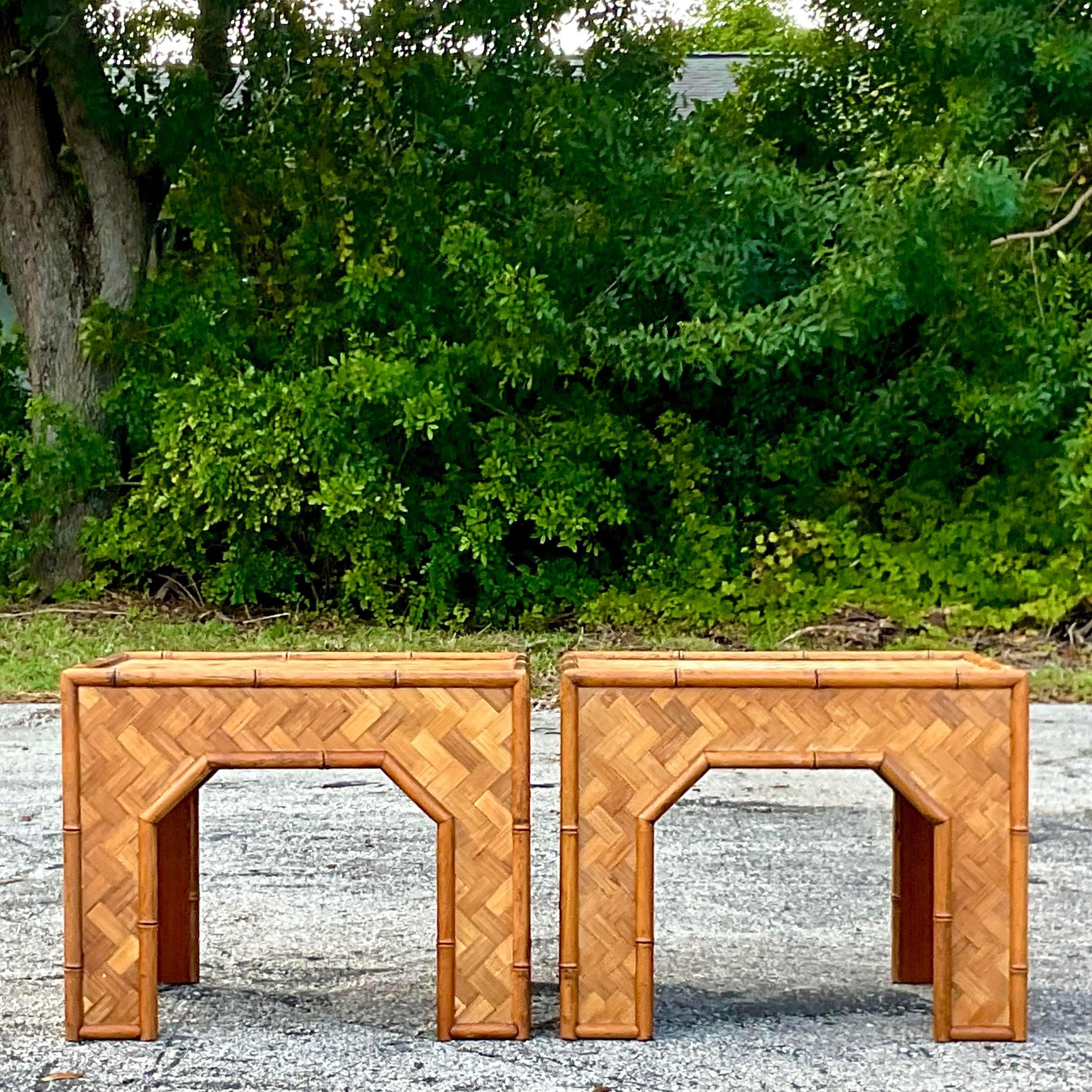 A fabulous pair of vintage Coastal side tables. A chic parquet rattan with rattan trim. Perfect as side tables, but also would be a great coffee table. You decide! Acquired from a Palm Beach estate.