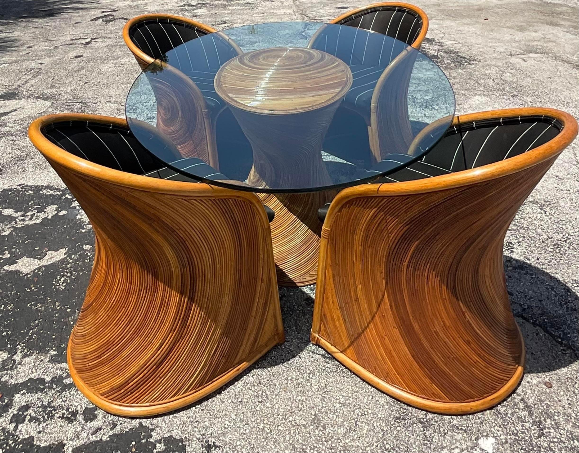 A fantastic vintage Boho dining table. A chic pencil reed construction with the radiating sun design. Matching dining chairs also available on my page. Acquired from a Miami estate. 
