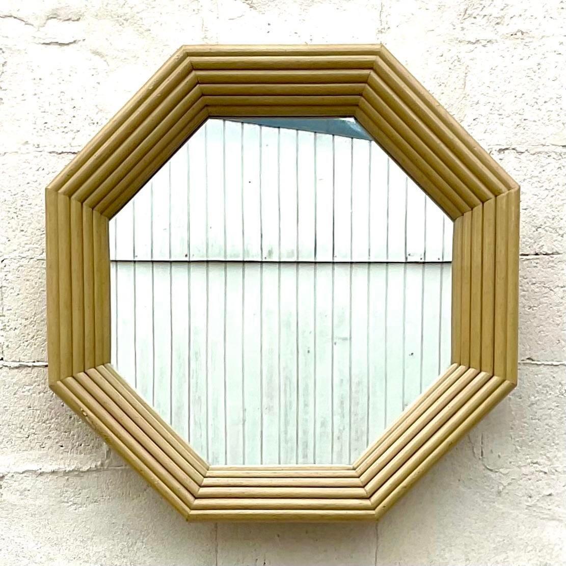 A fabulous vintage Coastal wall mirror. A chic rattan frame in an Octagonal shape. Acquired from a Palm Beach estate.