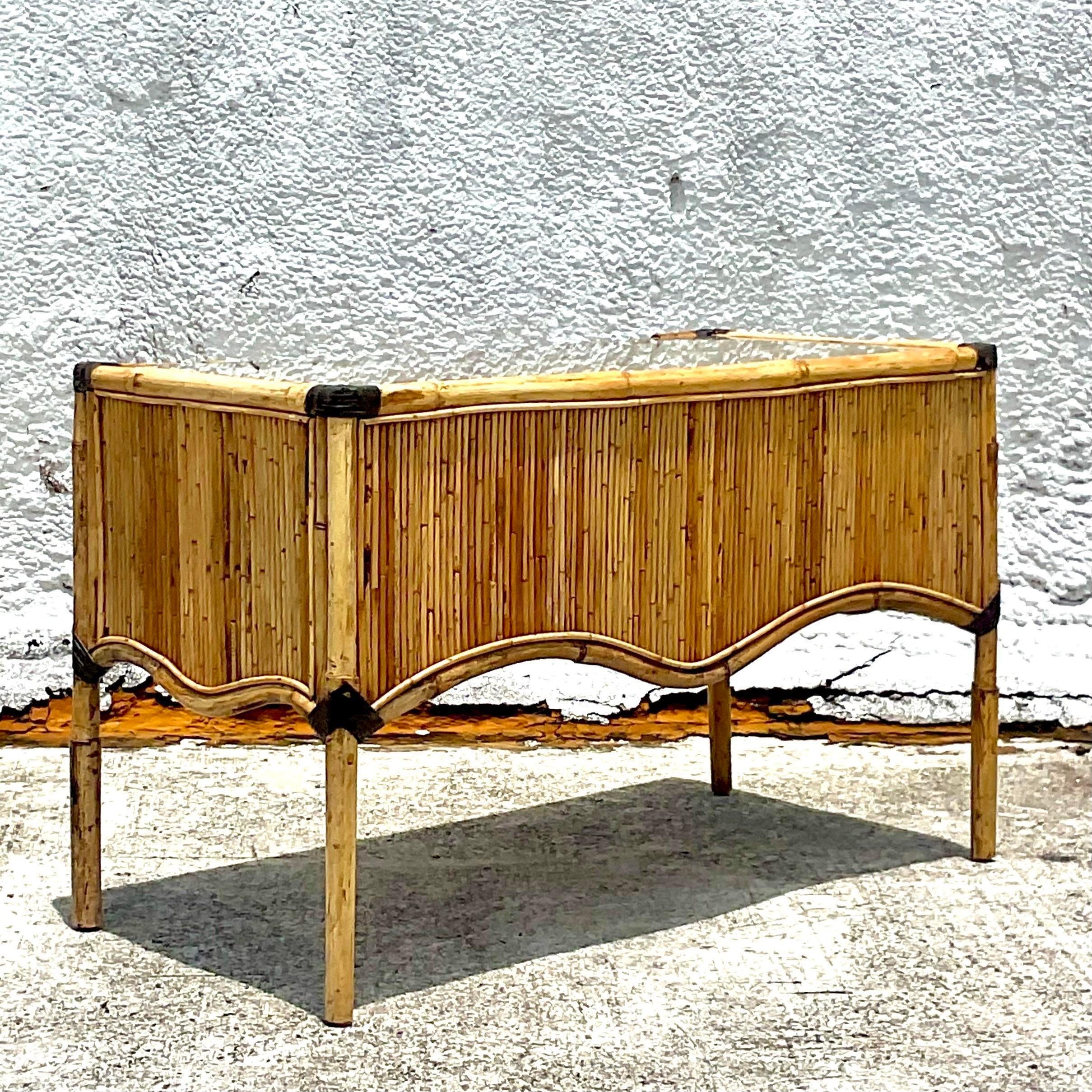 A fabulous vintage Coastal writing desk. A chic pencil reed frame with the most amazing and rare ruffle apron design. Inset glass top over pencil reed. Acquired from a Palm Beach estate. 
