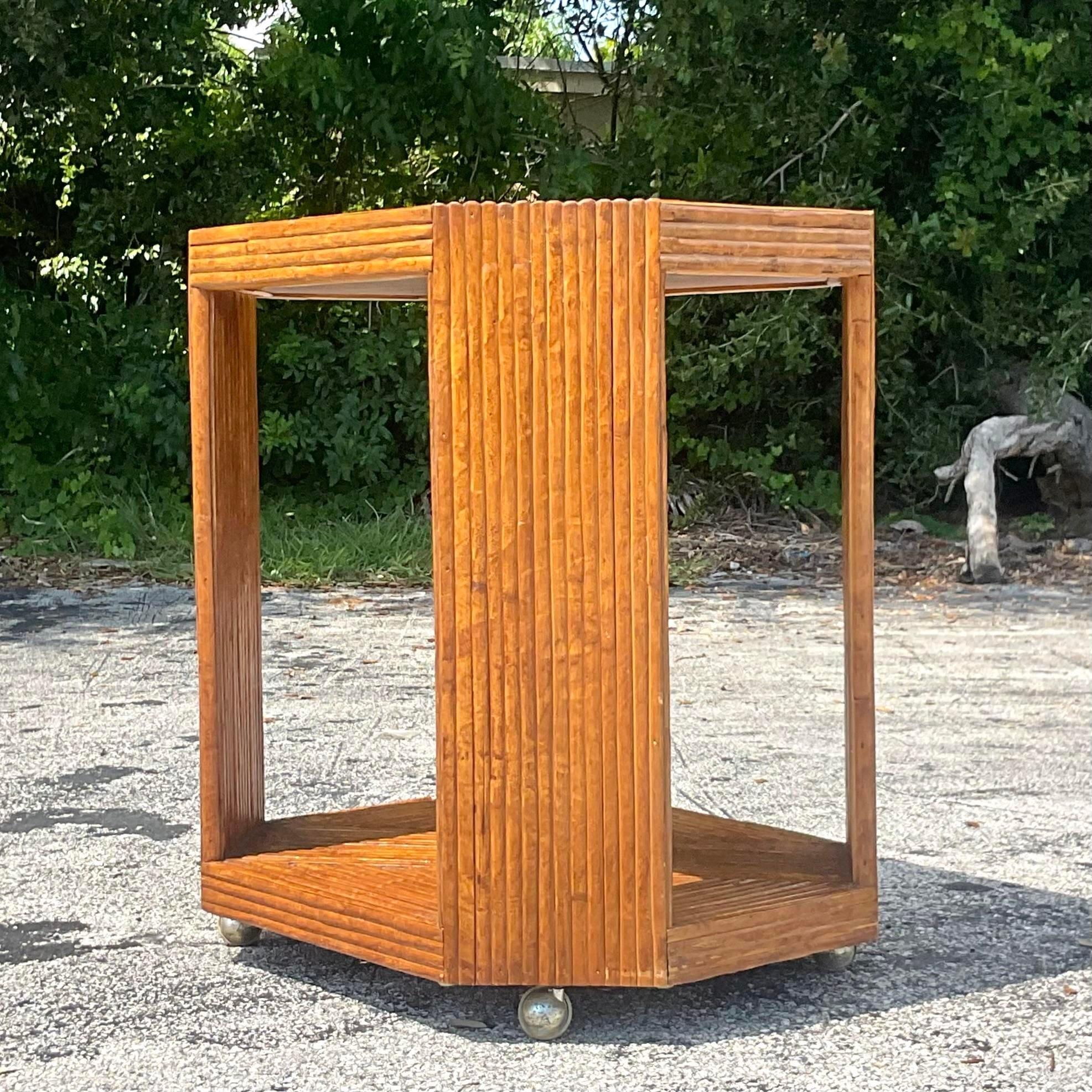 A fabulous vintage Coastal bar cart. A chic faceted design in a pretzel reed frame. Moves easily on casters. Perfect as a bar cart or even a chic TV stand. Acquired from a Miami estate. 