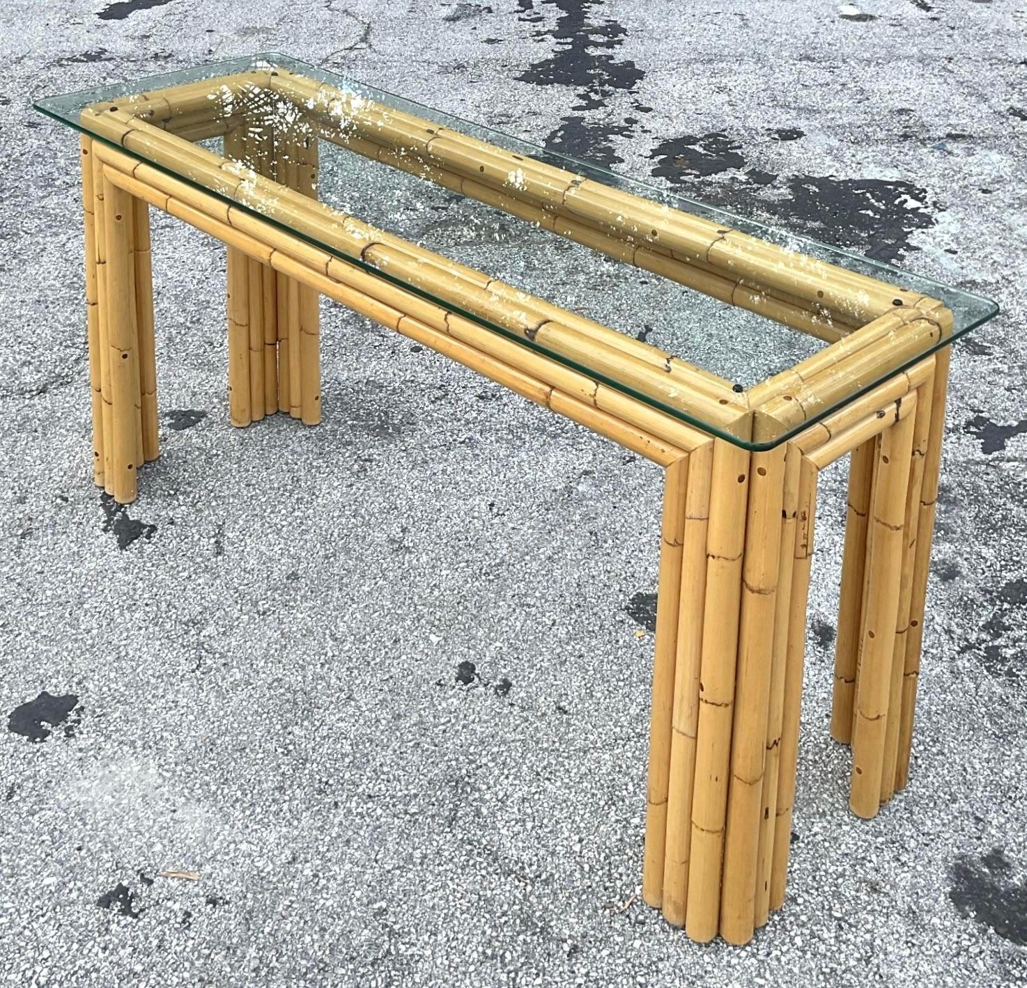 A fantastic vintage Coastal console table. A chic stacked rattan in a clean and linear design. Rare and unusual. Glass top rests on the frame. Acquired from a Palm Beach estate. 