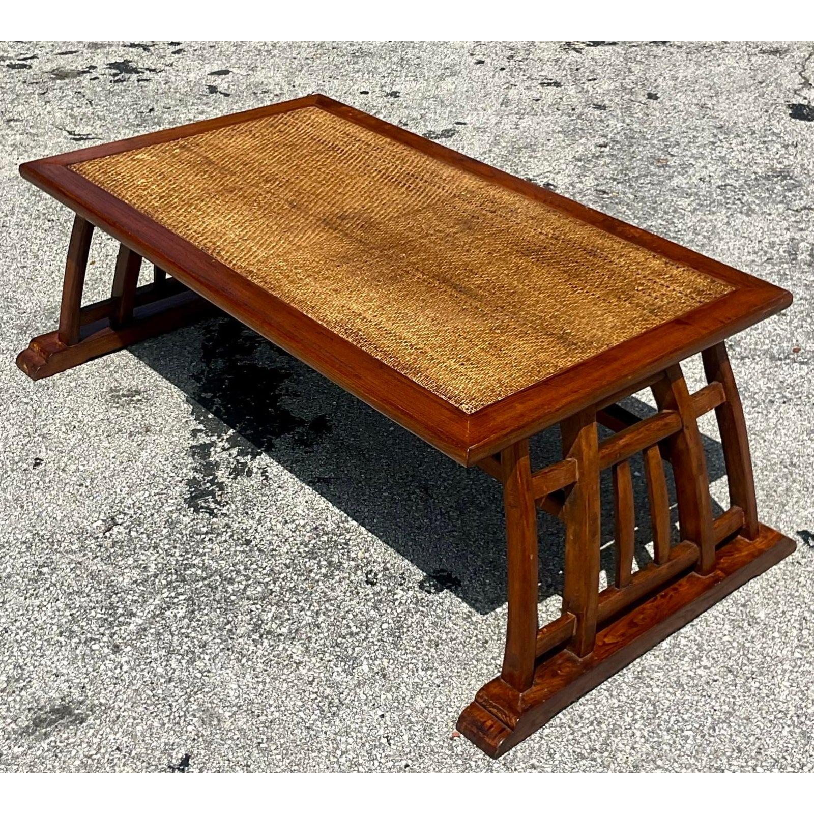 A fabulous vintage Coastal coffee table. A chic Teak wood frame with an inset woven rattan panel. Acquired from a Palm Beach estate.

The table is in great vintage co Siri on. Minor scuffs and blemishes appropriate to the age and use. Surface wear.