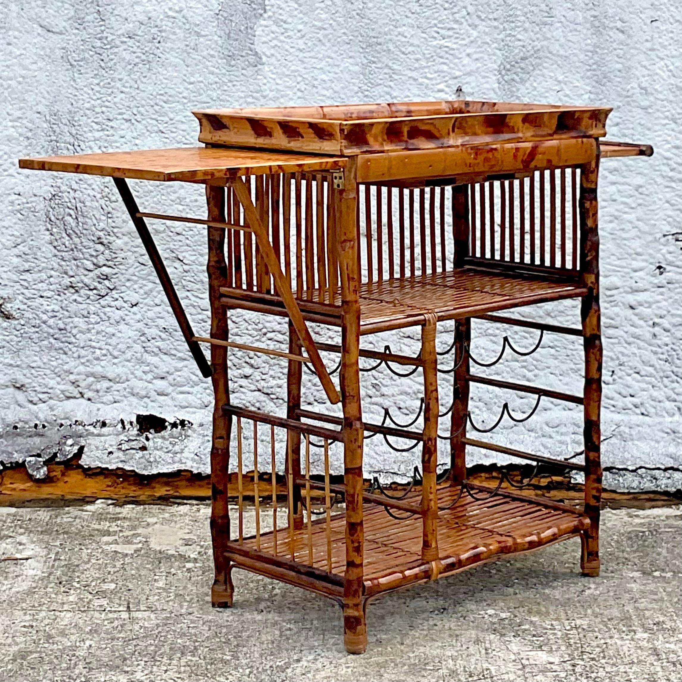 A fabulous vintage Coastal dry bar. A chic tortoise shell split bamboo with metal wire frame bottle holders. Extendable surface space that folds away for easy storage. Acquired from a Palm Beach estate.

Left side shelf 15.5
Right side pull out