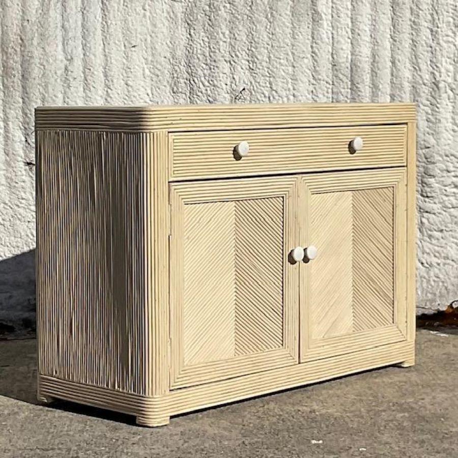 A fabulous vintage Coastal sideboard. A chic washed pencil reed in a clean and modern design. Lots of great storage below. Acquired from a Palm Beach estate. 