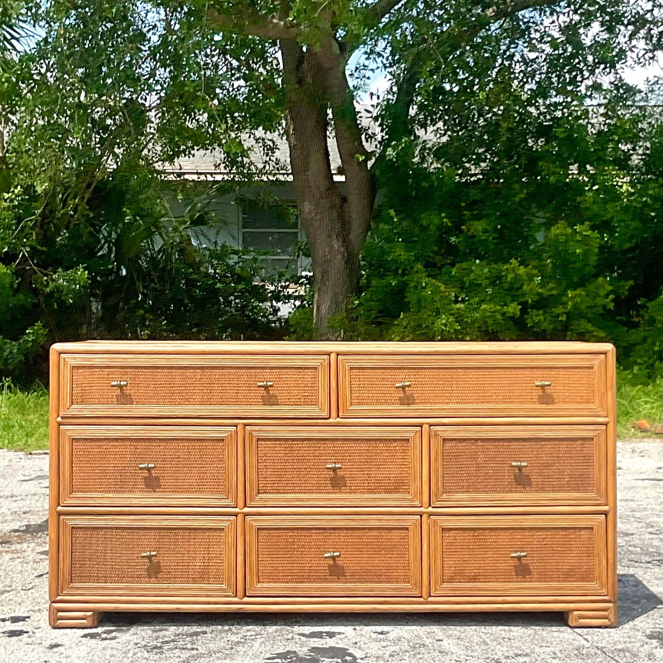 A fabulous vintage Coastal 8 drawer dresser. Made by the iconic Ficks Reed group and tagged in the drawer. Chic wood frame with inset woven rattan panels. Acquired from a Palm Beach estate.