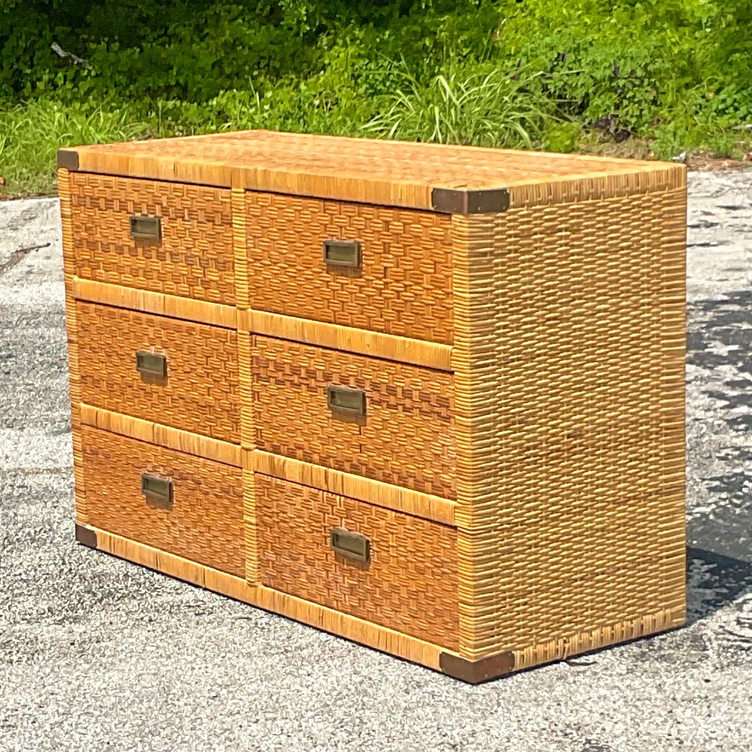 A fabulous vintage z coastal dresser. A chic woven rattan frame with brass campaign hardware. Matching nightstands also available on my page. Acquired from a Palm Beach estate.