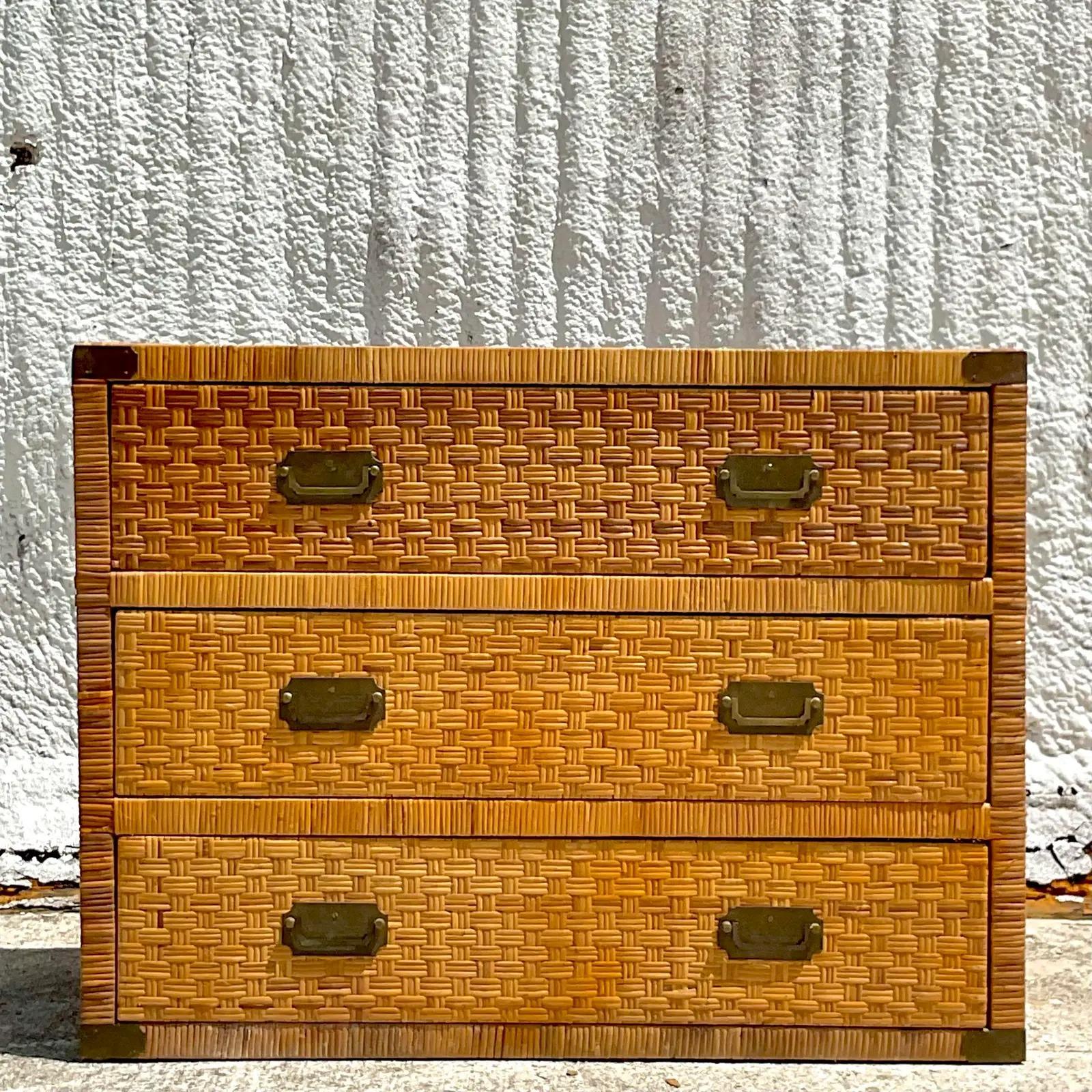 Fantastic vintage Coastal chest of drawers. A beautiful woven rattan with brass campaign hardware. A classic for any décor. Acquired from a Palm Beach estate.