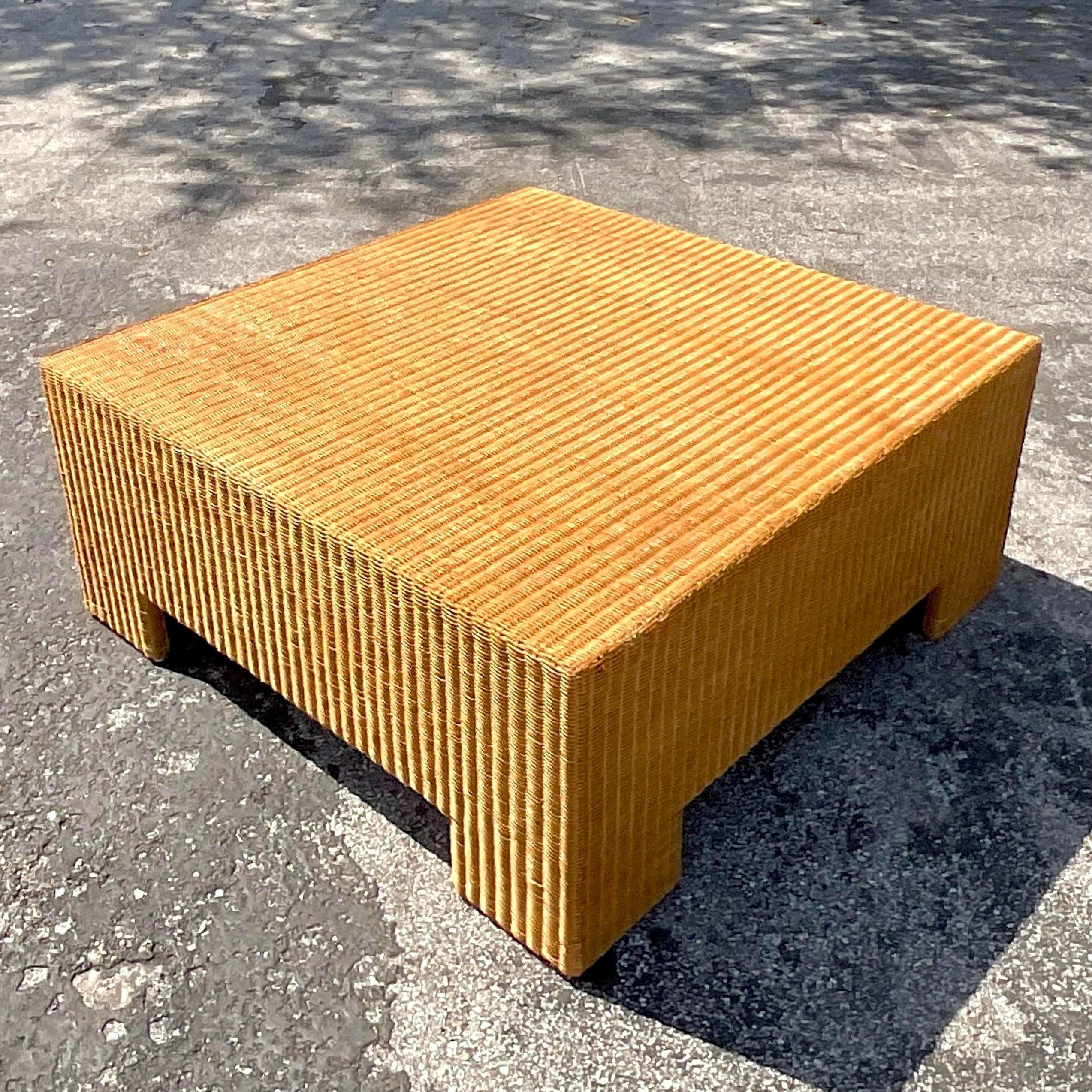 A fabulous vintage Coastal coffee table. A chic tightly woven rattan in a classic Parsons shape. Acquired from a Palm Beach estate