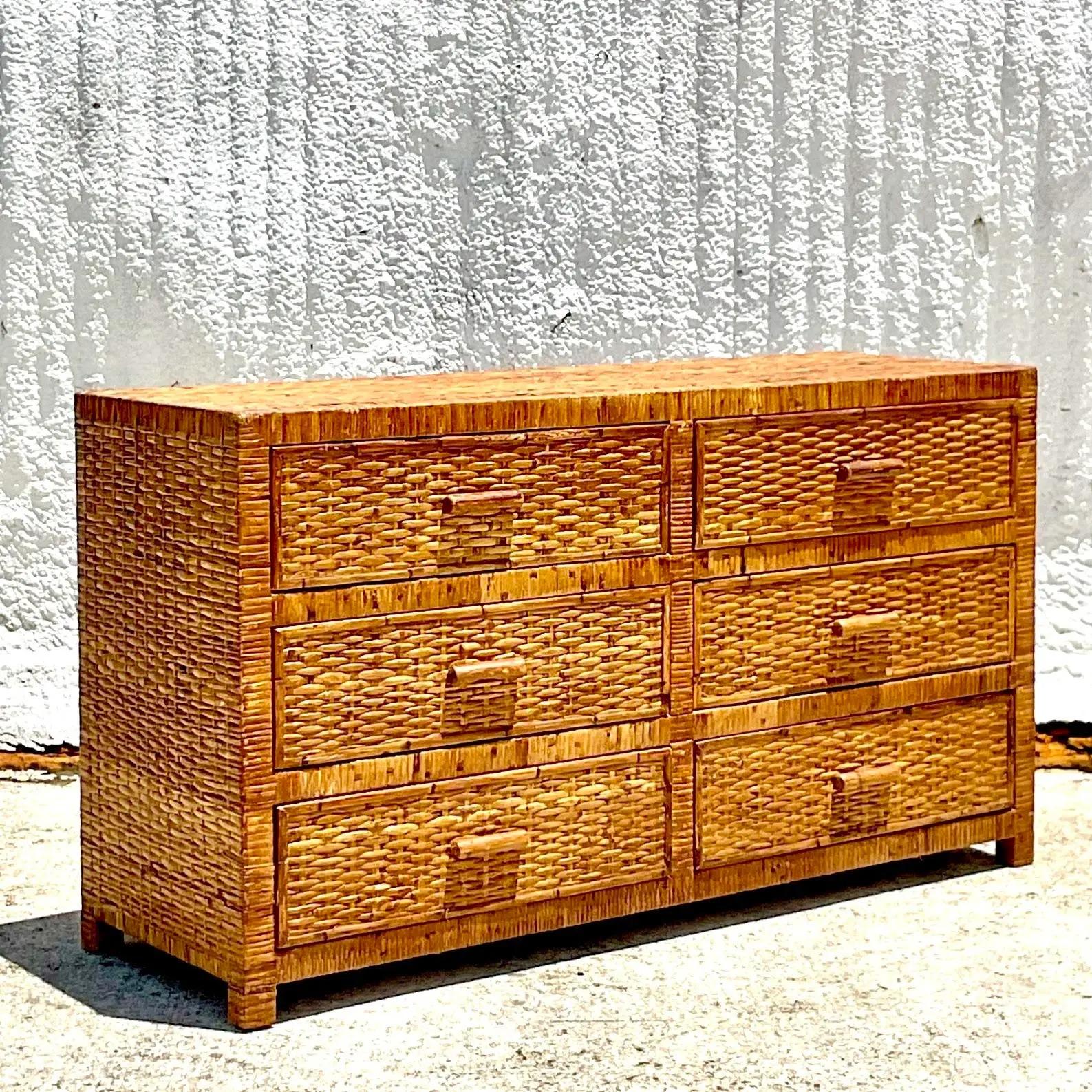 A vintage Coastal dresser. A chic woven rattan in a chic woven rattan. Acquired from a Palm Beach estate.