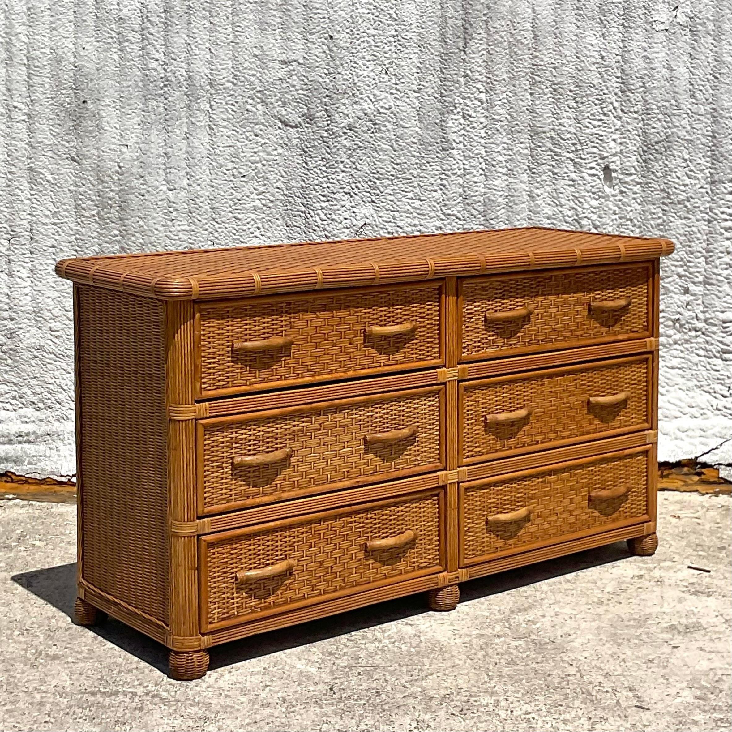 Bring coastal charm into your home with this Vintage Coastal Woven Rattan Dresser. Crafted with natural rattan and featuring a woven design, this dresser embodies the relaxed elegance of American coastal style. With ample storage and organic