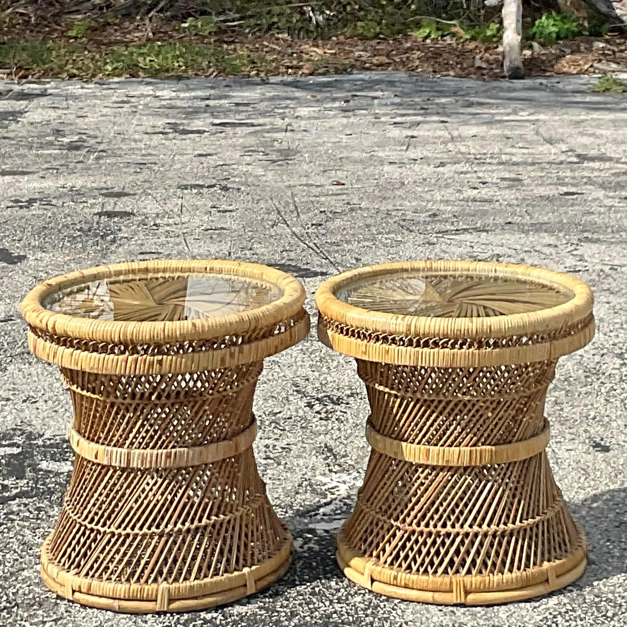 A fabulous pair of vintage Coastal drink tables. Chic open weave rattan in a charming round shape. Inset glass tops. Acquired from a Palm Beach estate. 