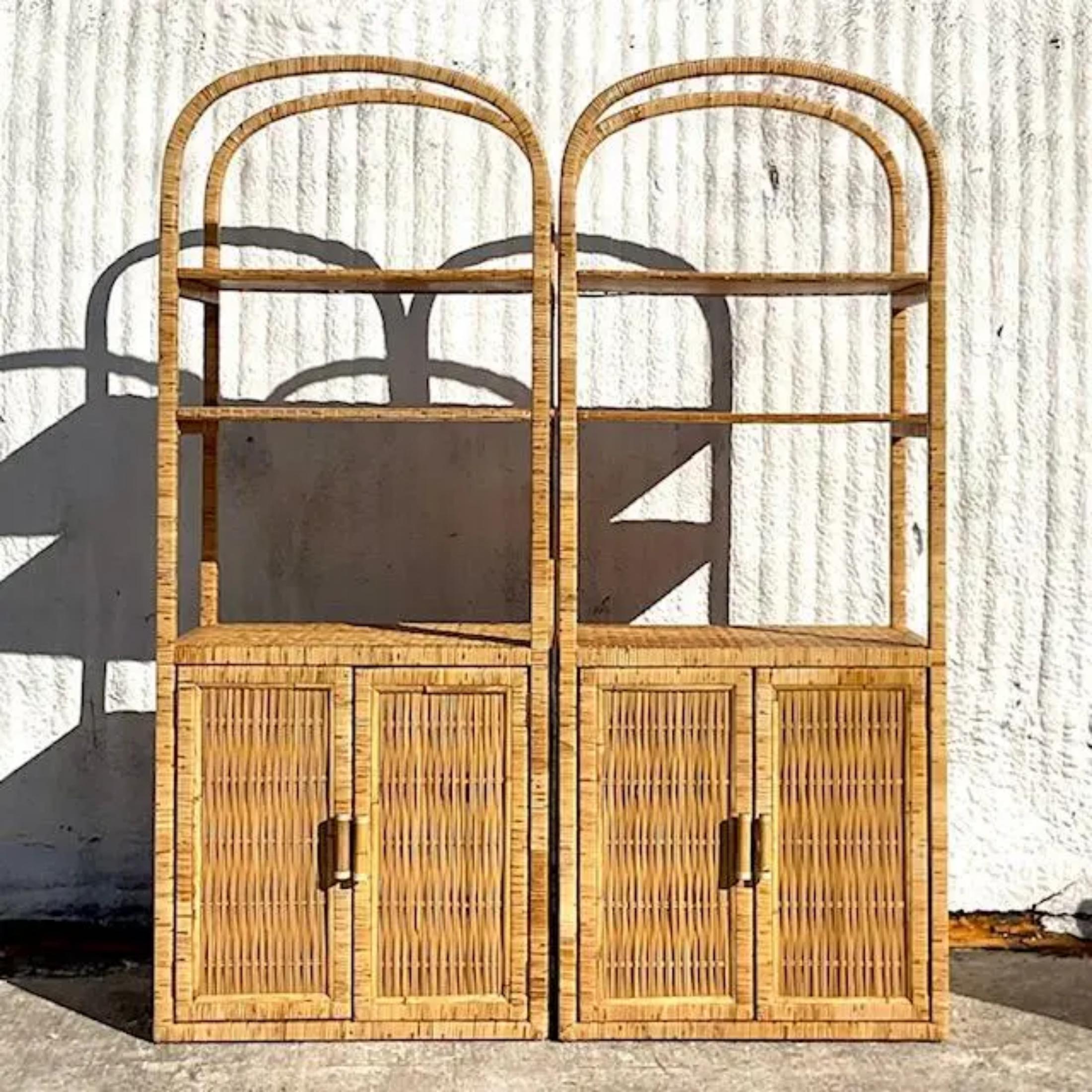 A fabulous pair of vintage Coastal etagere. A chic woven rattan in a clean arched design. Inset woven rattan shelves. Acquired from a Palm Beach estate