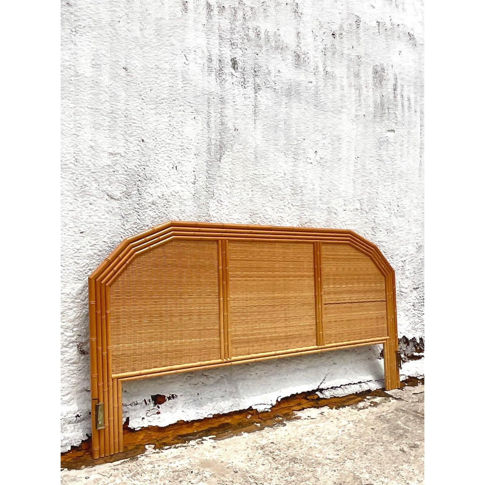 A super chic vintage Coastal King headboard. Beautiful notched rattan frame with inset woven rattan panels. Acquired from a Palm Beach estate.
