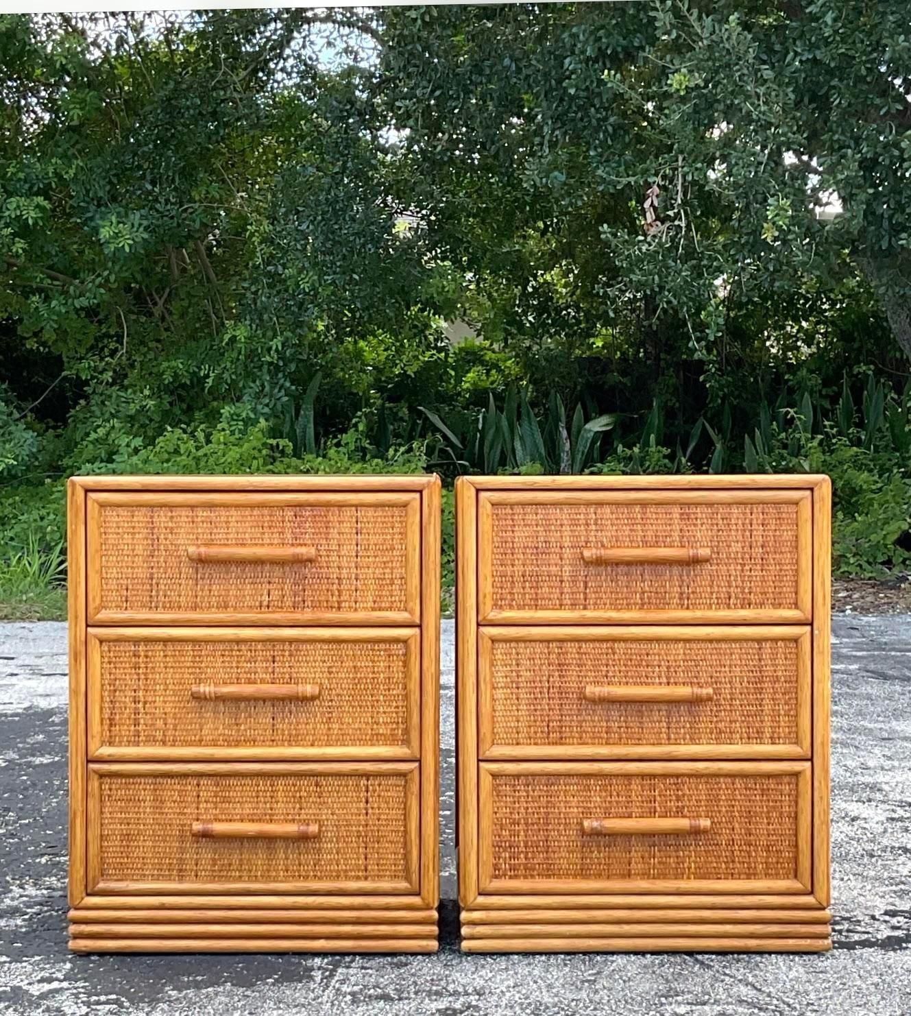 A fabulous pair of vintage Coastal nightstands. Chic rattan frame with woven rattan drawer fronts. A laminate top makes them extra durable. Greta looking and functional! Acquired from a Palm Beach estate.
